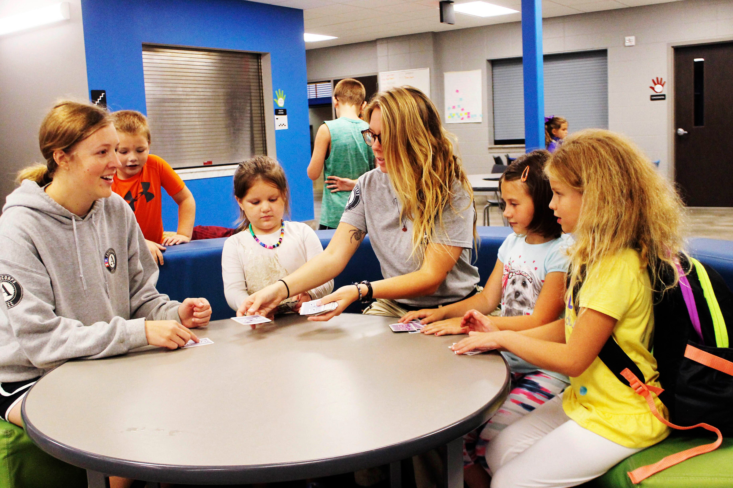AmeriCorps members play cards with Watertown S.D. Boys and Girls Club members on Aug. 14, 2019. (Dan Crisler—The Public Opinion via AP)