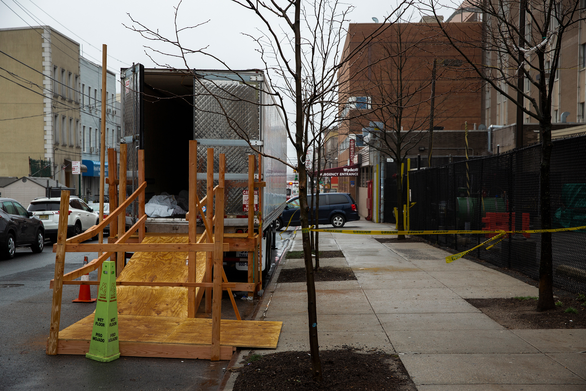 A covered body is seen in the back of a temporary morgue erected outside Wyckoff Heights Medical Center in Brooklyn, New York, on March 29, 2020. (Benjamin Norman for TIME)