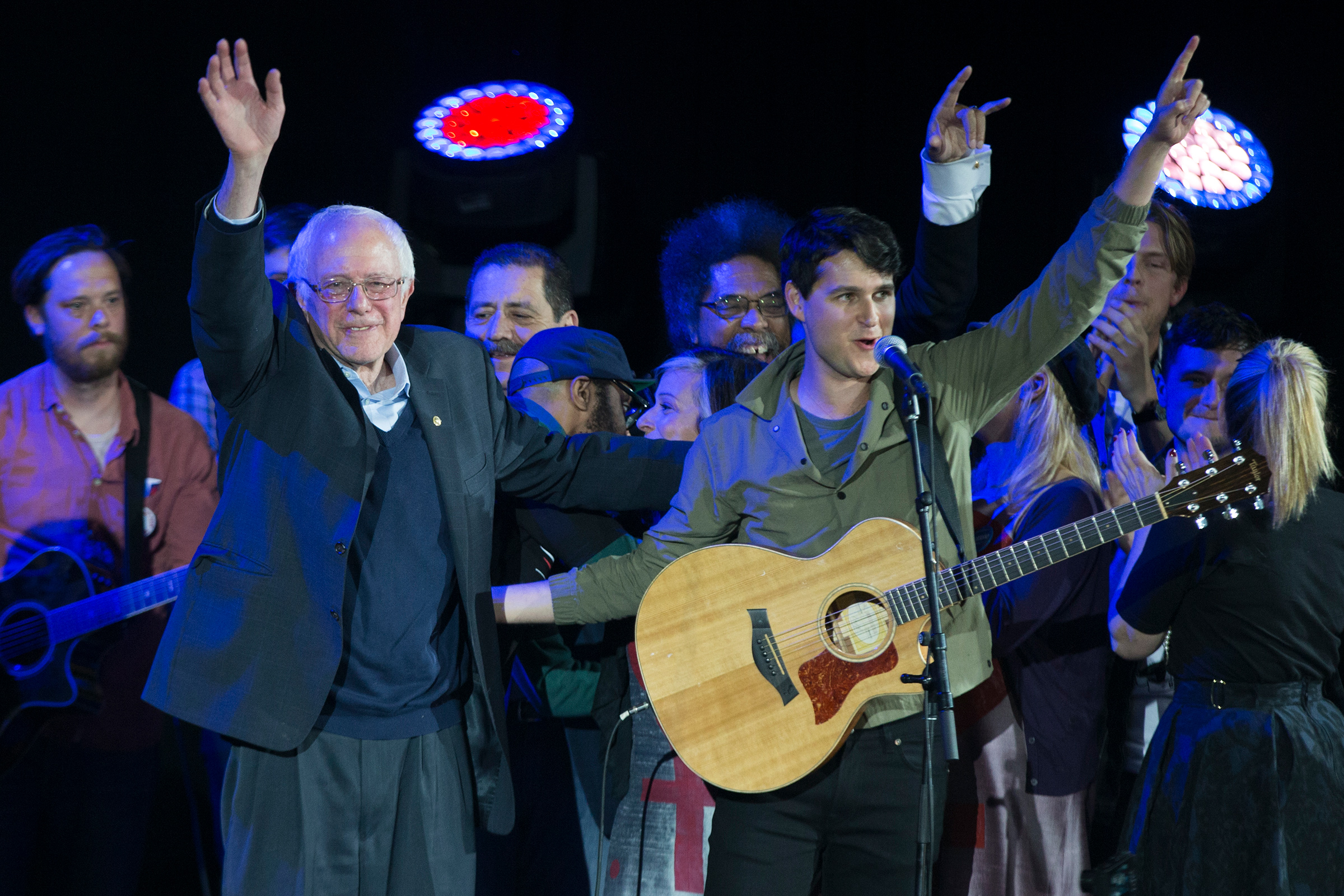 Democratic presidential candidate Sen. Bernie Sanders, and Vampire Weekend lead singer Ezra Koenig wave during a campaign rally at the University of Iowa on Jan. 30, 2016 (Evan Vucci—AP)