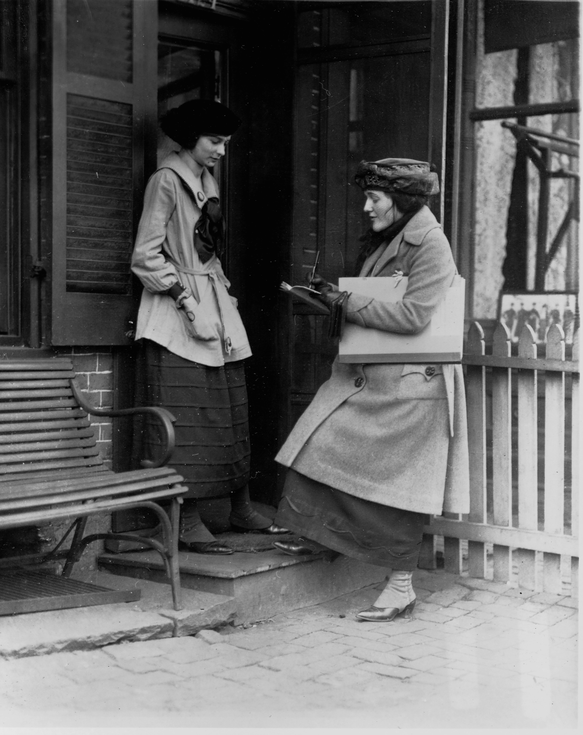 A Census taker asks questions of a woman at the door of her house, early 20th century. (Corbis/VCG/Library of Congress via Getty Images)