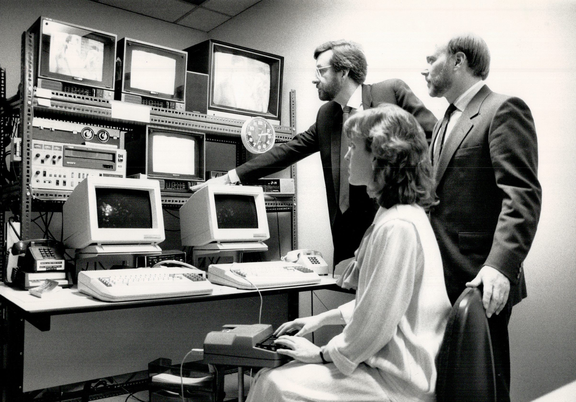 In 1988, three Canadian Captioning Development Agency employees watch television monitors in a studio where closed captioning is done. (Toronto Star via Getty Images)