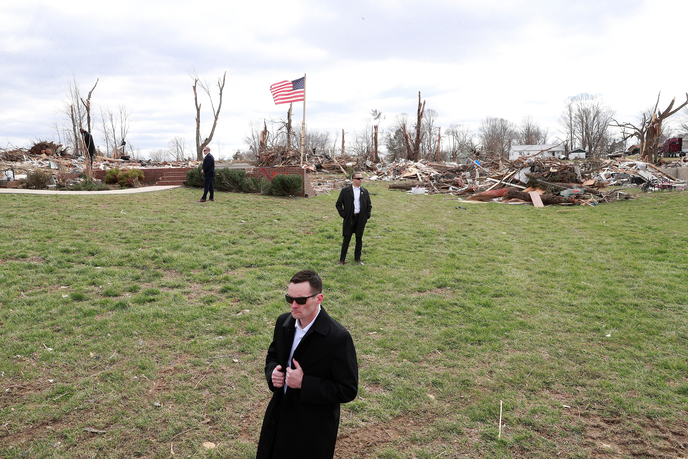 U.S. Secret Service agents stand by as President Trump, not pictured, observes tornado damage in Cookeville, east of Nashville, on March 6, 2020. (Tom Brenner—Reuters)