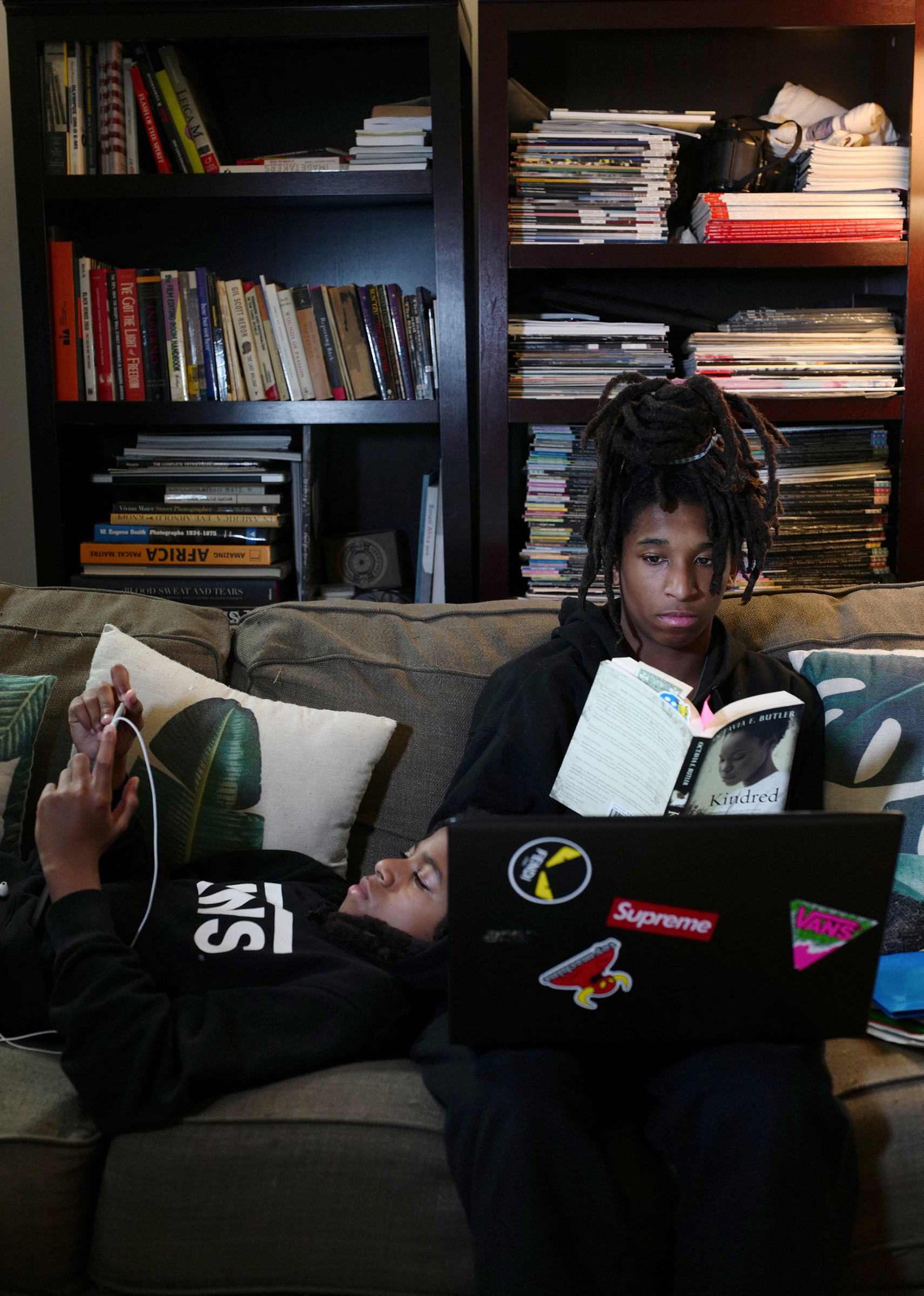 Mosijah Roye, 15, right, and Iyeoshujah, 11, the photographer’s sons, follow online classes in New York on March 23 on their home devices