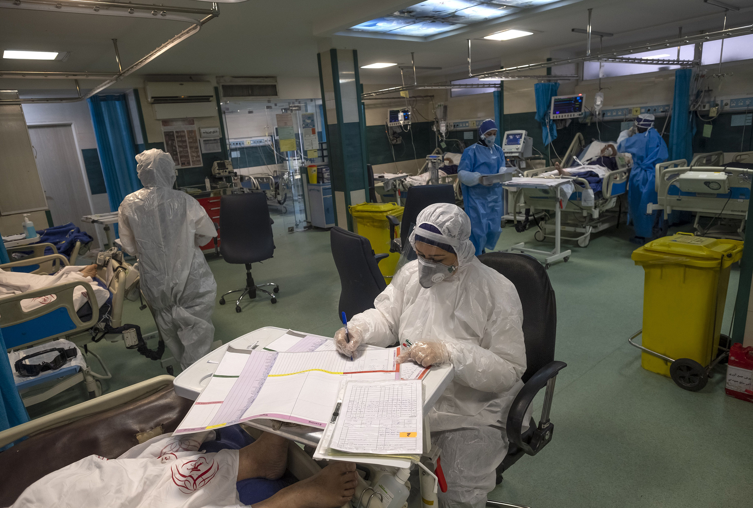 An Iranian medical personnel wearing protective gear works at a quarantine section of the Rassolakram hospital in western Tehran following a new coronavirus outbreak in Iran on March 11. (Morteza Nikoubazl—SIPA)