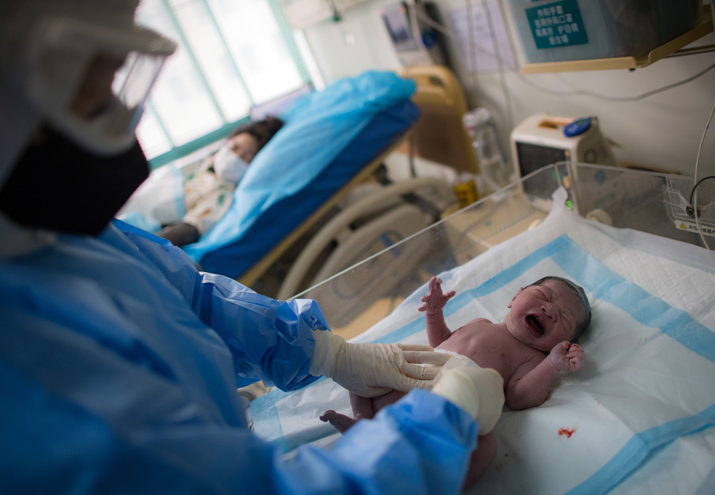 Midwife Wu Dan takes care of Liu Ting's baby at the delivery room of Wuhan Maternal and Child Health Hospital in Wuhan, central China's Hubei Province, March 1, 2020. (Xiao Yijiu—Xinhua/Getty Images)