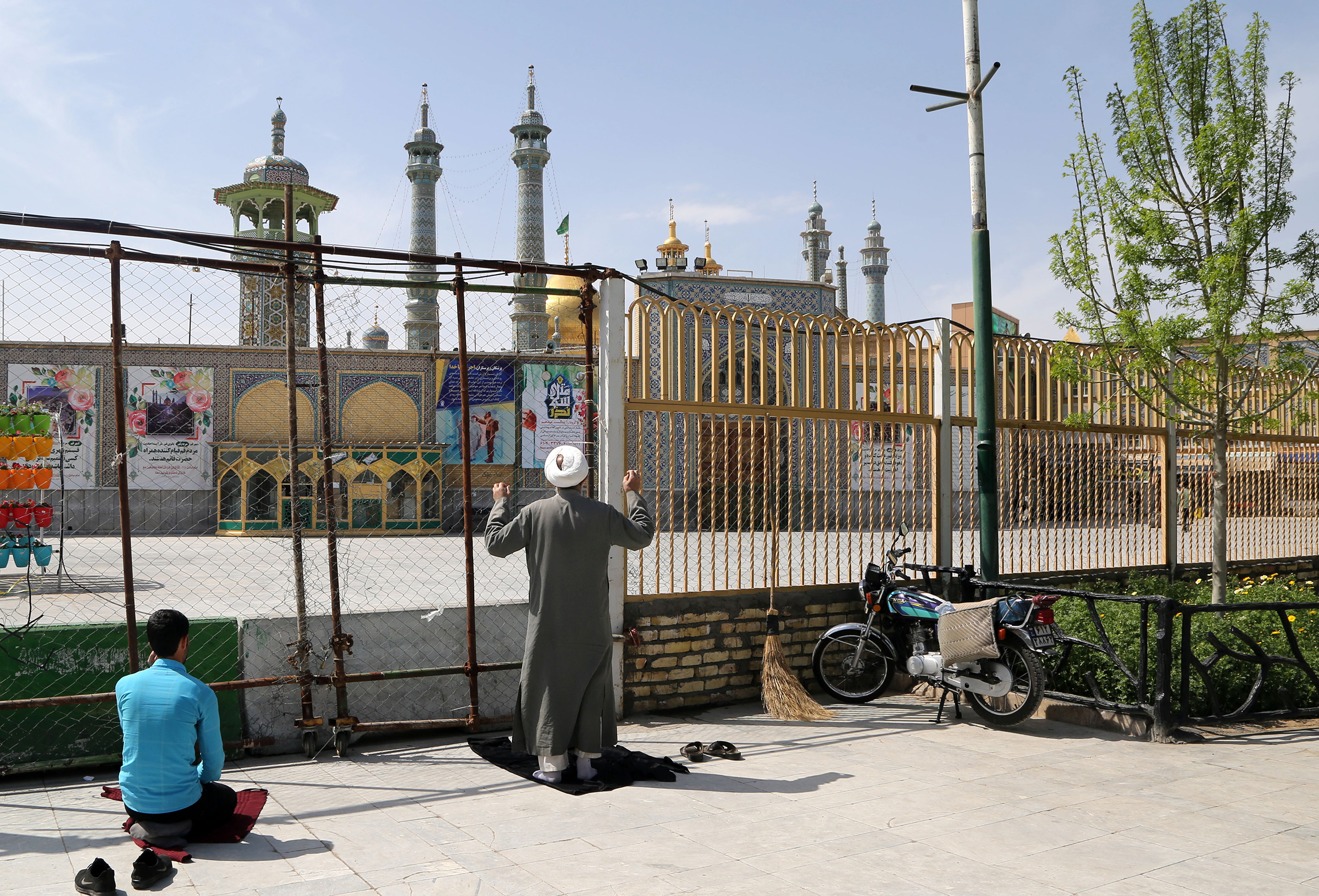 People continue to pray outside of Fatima Masumeh Shrine as it is closed for visitors due to the spread of COVID-19 in Qom, Iran on March 17.