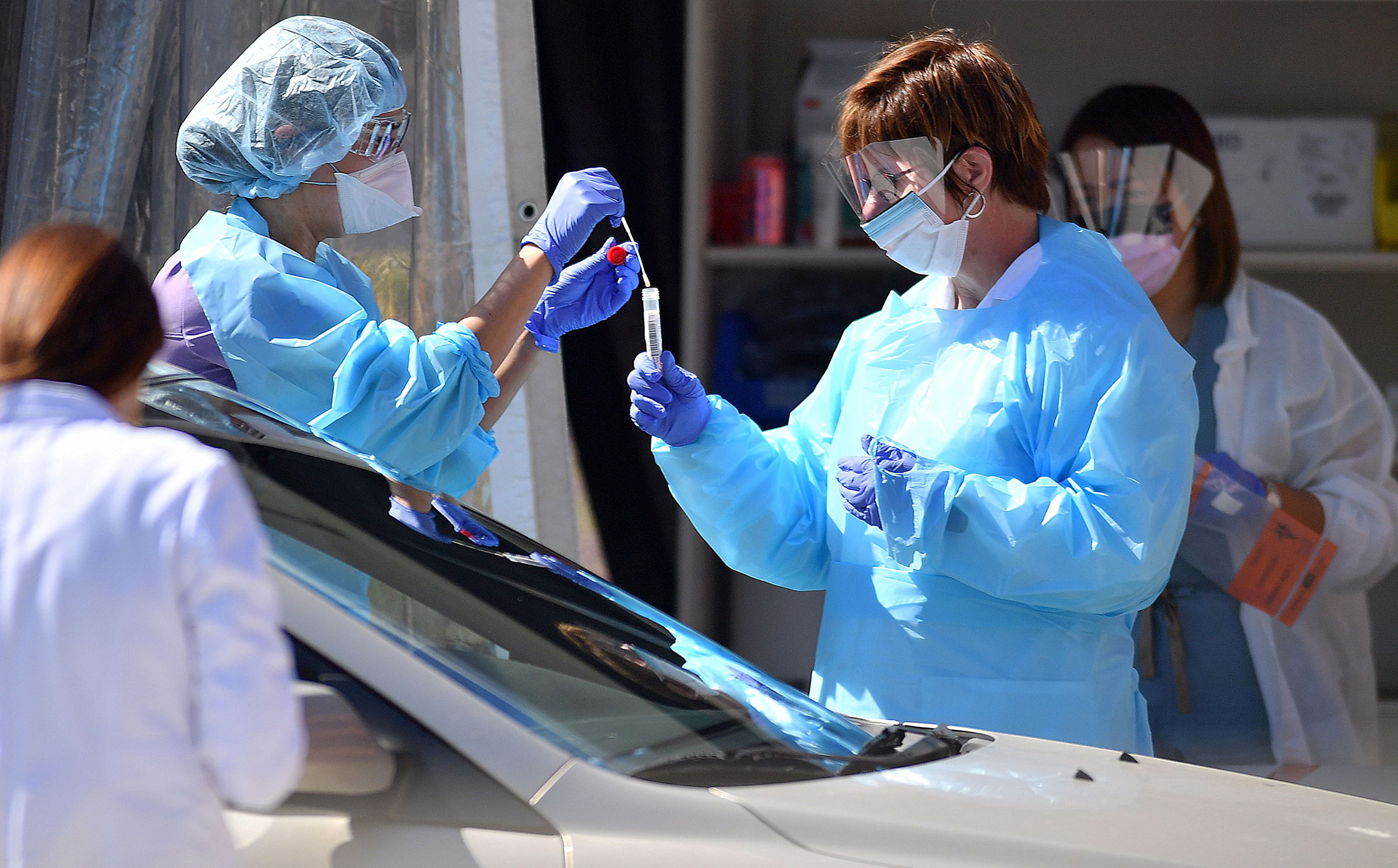 Medical workers test a patient for the novel coronavirus, COVID-19, at a drive-thru testing facility in San Francisco, California on March 12, 2020. (Josh Edelson—AFP via Getty Images)