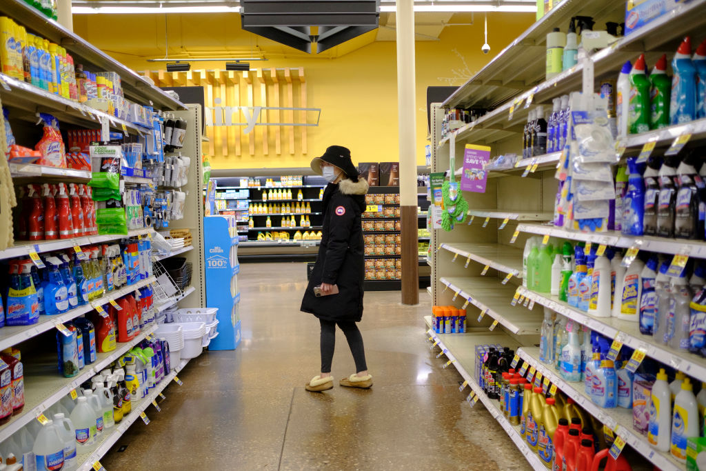 A woman wearing a mask shops for cleaning supplies at a Kroger in Bloomington. (Jeremy Hogan—Barcroft Media/Getty Images)