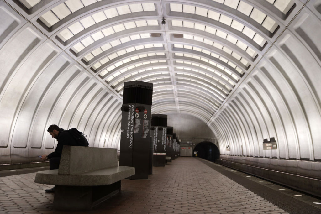 A passenger waits for his train at an almost empty platform at Woodley Park-Zoo/Adams Morgan Metro station in Washington, D.C. on Mar. 16, 2020. (Alex Wong—Getty Images)