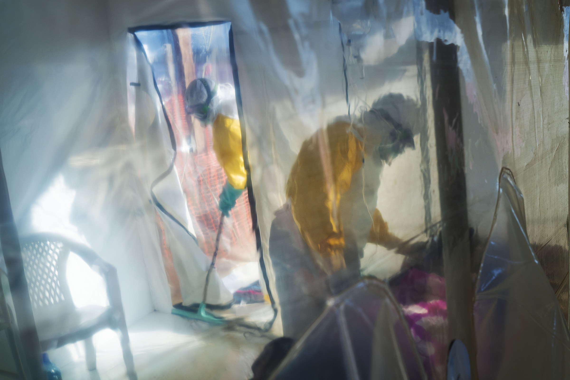 Health workers wearing protective suits tend to an Ebola victim kept in an isolation cube in Beni, Congo on March 13, 2019. (Jerome Delay—AP)