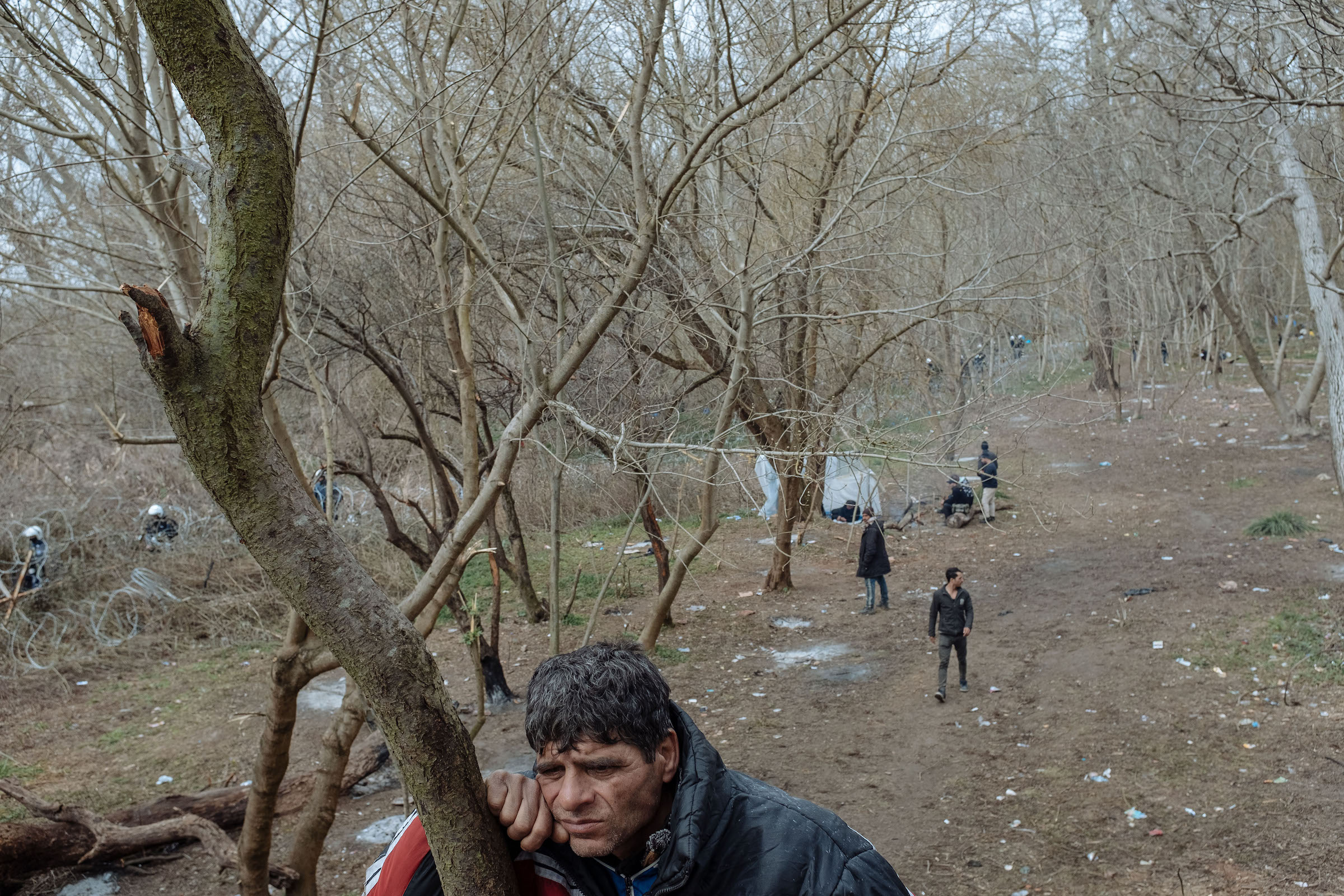 Muhammed, who fled Syria three years ago and was living in the Turkish city of Mersin, rests against a tree in Edirne.