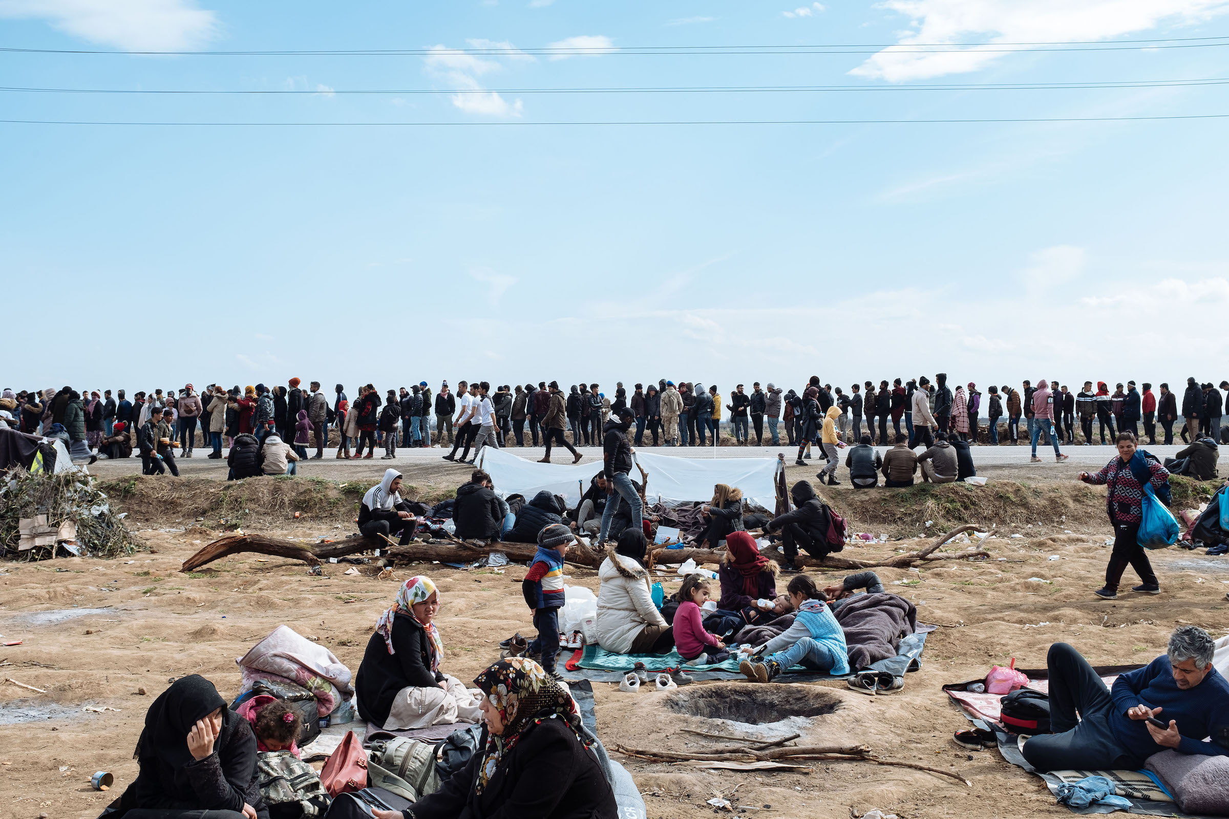 Thousands of migrants wait in a buffer zone between Turkey and Greece at the Pazarkule border gate in Edirne.