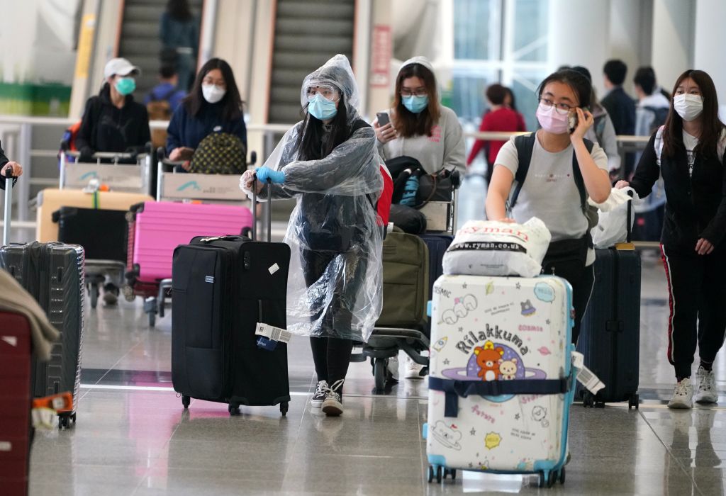 Travelers arrive at Hong Kong International Airport in Hong Kong on Mar. 18, 2020. (TPG/Getty Images)