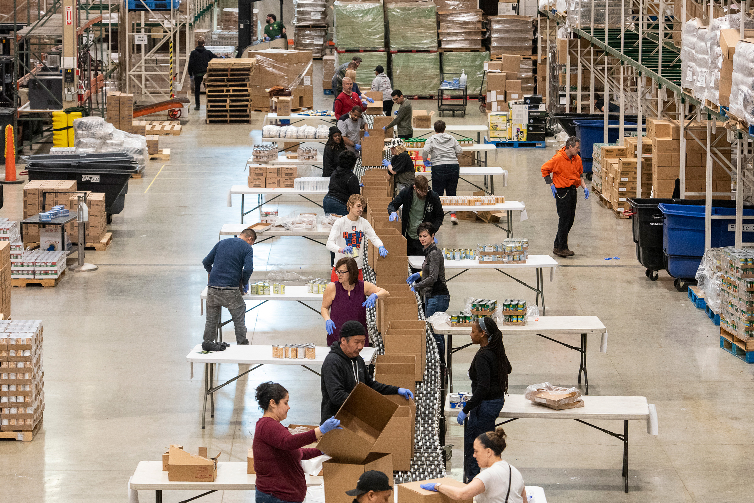 Volunteers help break down and repackage food at the Greater Chicago Food Depository on Mar. 24