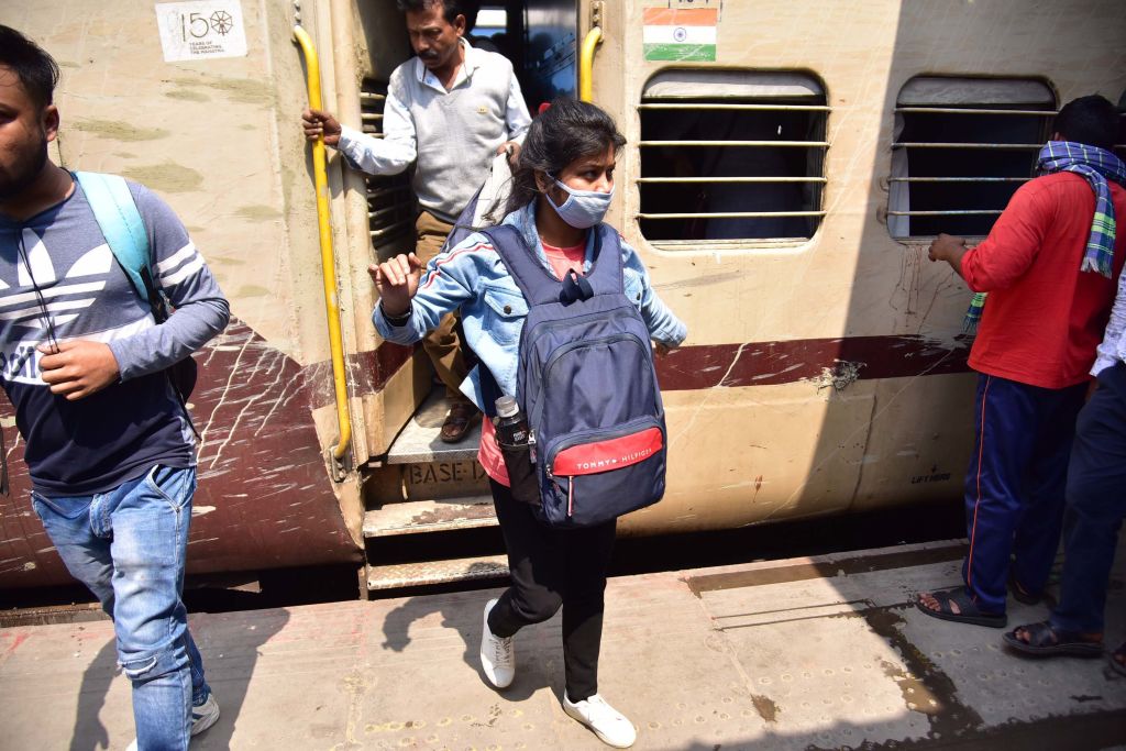 Travelers wear masks as a preventative measure against coronavirus at a Railway Station in Guwahati in India on March 12. (Anuwar Ali Hazarika—Barcroft Studios/Getty Images)