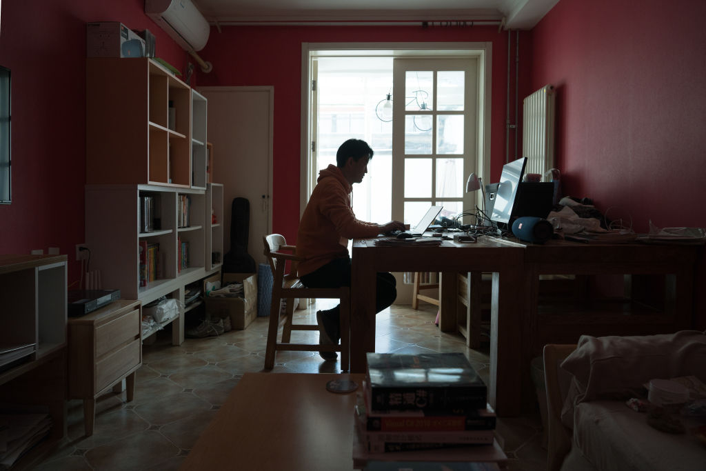 Michael Wang, 49, IT worker from Beijing, works on the laptop in his house on March 4, 2020 in Beijing, China. (Getty Images&mdash;2020 Andrea Verdelli)