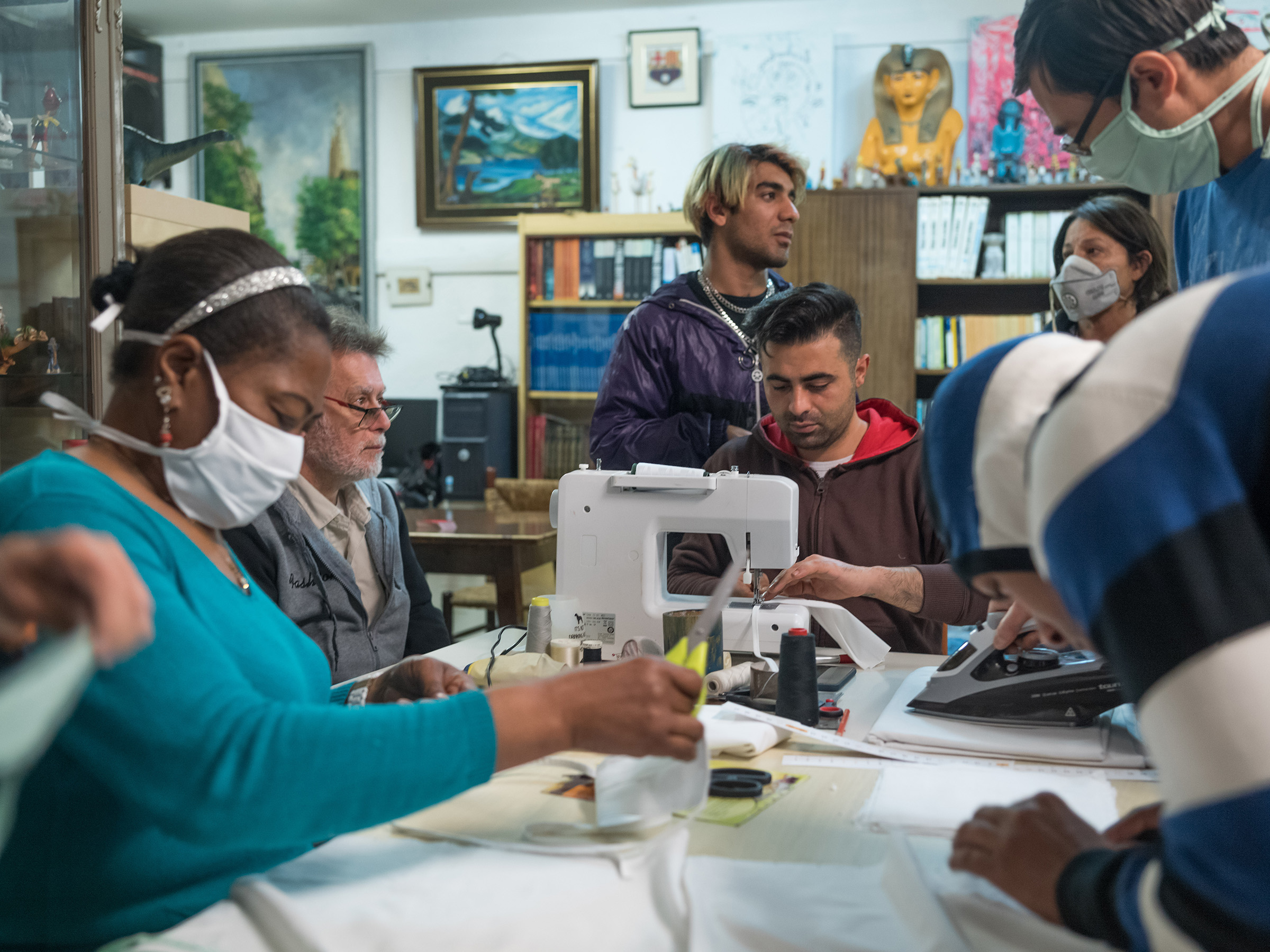 Residents of Casa Cádiz, a shelter for homeless people and refugees in Barcelona, produce face masks for use in hospitals and nursing homes (Samuel Aranda—The New York Times/Redux)
