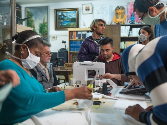 Residents of Casa CÃ¡diz, a shelter for homeless people and refugees in Barcelona, produce face masks for use in hospitals and nursing homes