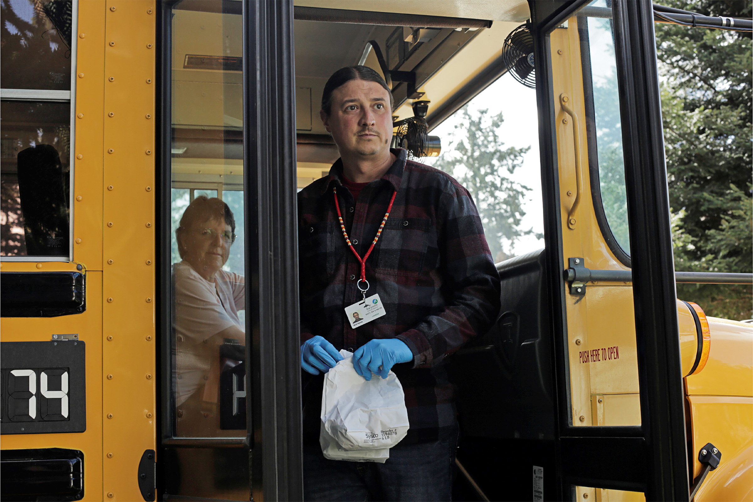 Matt Remle, a Native liaison with the now shut-down Marysville School District, delivers sack lunches to students on the Tulalip Indian Reservation in Washington State (David Ryder—Reuters)