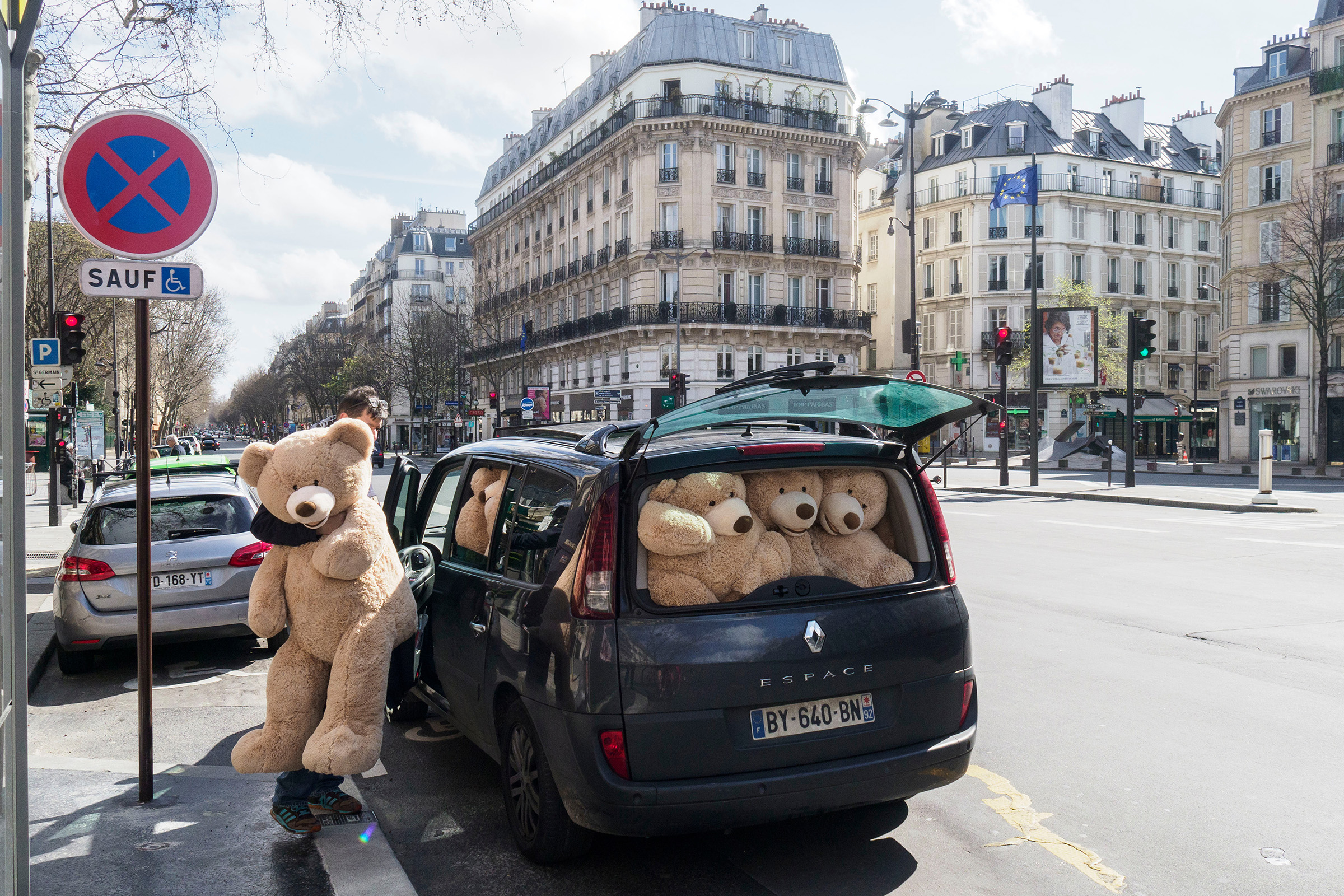 A man distributes giant teddy bears along emptied streets in Paris on March 15, the first day of the city’s lockdown; nine days later, residents were allowed outside only for exercise once a day, within 1 km of their homes (Thomas Dworzak—Magnum Photos)