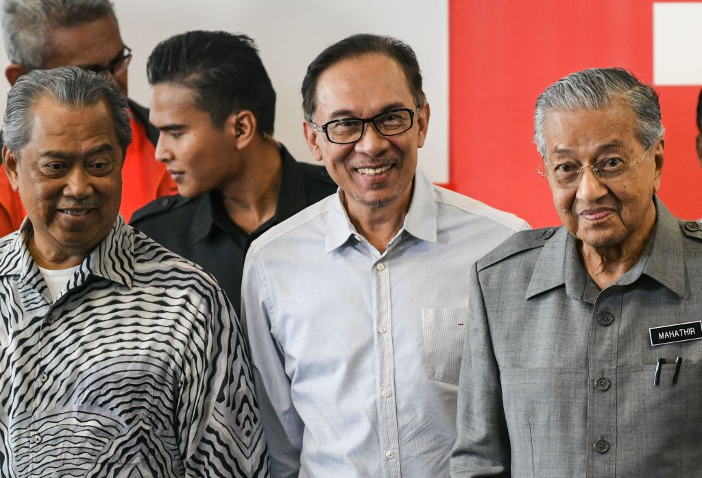 Malaysia's Prime Minister Mahathir Mohamad (R), politician Anwar Ibrahim (C) and Minister of Home Affairs Muhyiddin Yassin leave after a press conference in Kuala Lumpur on June 1, 2018. (MOHD RASFAN—AFP/Getty Images)