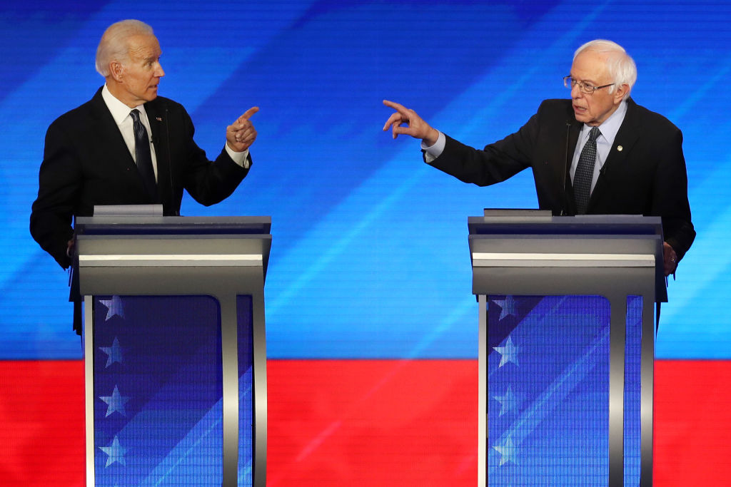 Democratic presidential candidates former Vice President Joe Biden and Vermont Sen. Bernie Sanders participate in the Democratic presidential debate on Feb. 07, 2020 in Manchester, New Hampshire. (Joe Raedle—Getty Images)