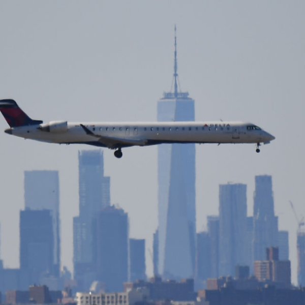 A plane from Delta Air Lines is seen above the skyline of Manhattan before it lands at JFK airport on March 15, 2020 in New York City.