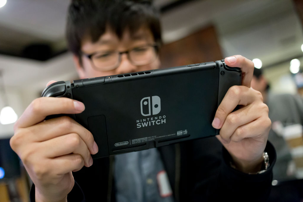 Man playing with a Nintendo Switch video game console. (ullstein bild via Getty Images—ullstein bild - Dünzl)