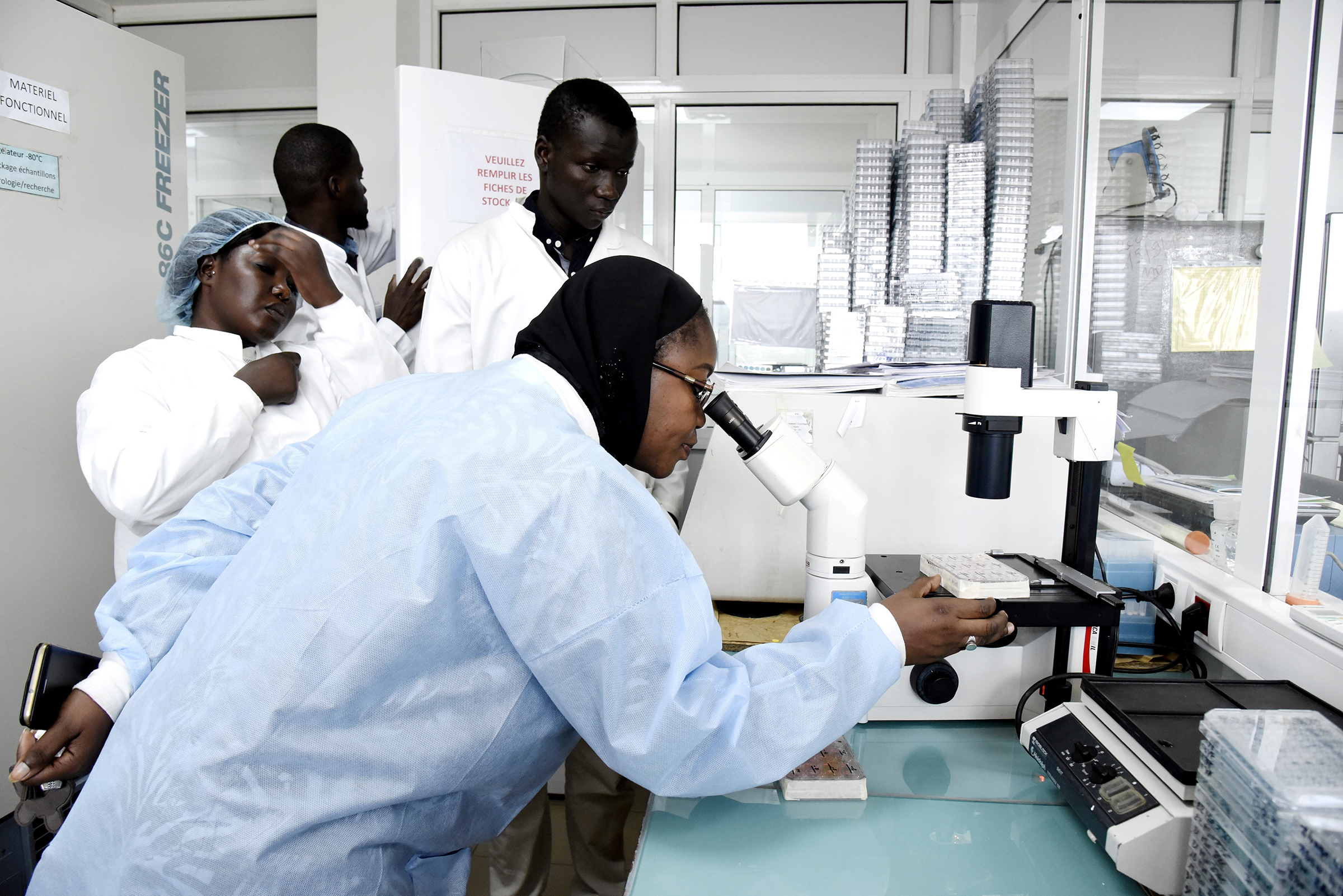 Scientific staff members work in a secure laboratory, researching the coronavirus, at the Pasteur Institute in Dakar, Senegal, on Feb. 3, 2020. (Seyllou—AFP/Getty Images)