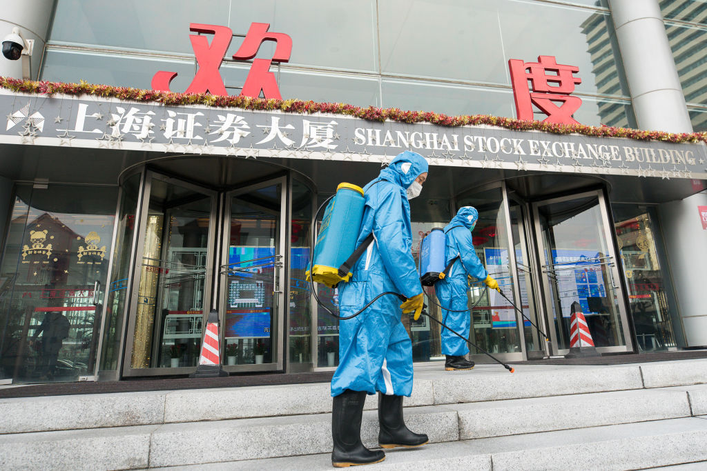 Medical workers spray antiseptic outside of the main gate of Shanghai Stock Exchange Building on Feb. 03, 2020 in Shanghai, China. (Yifan Ding–Getty Images)