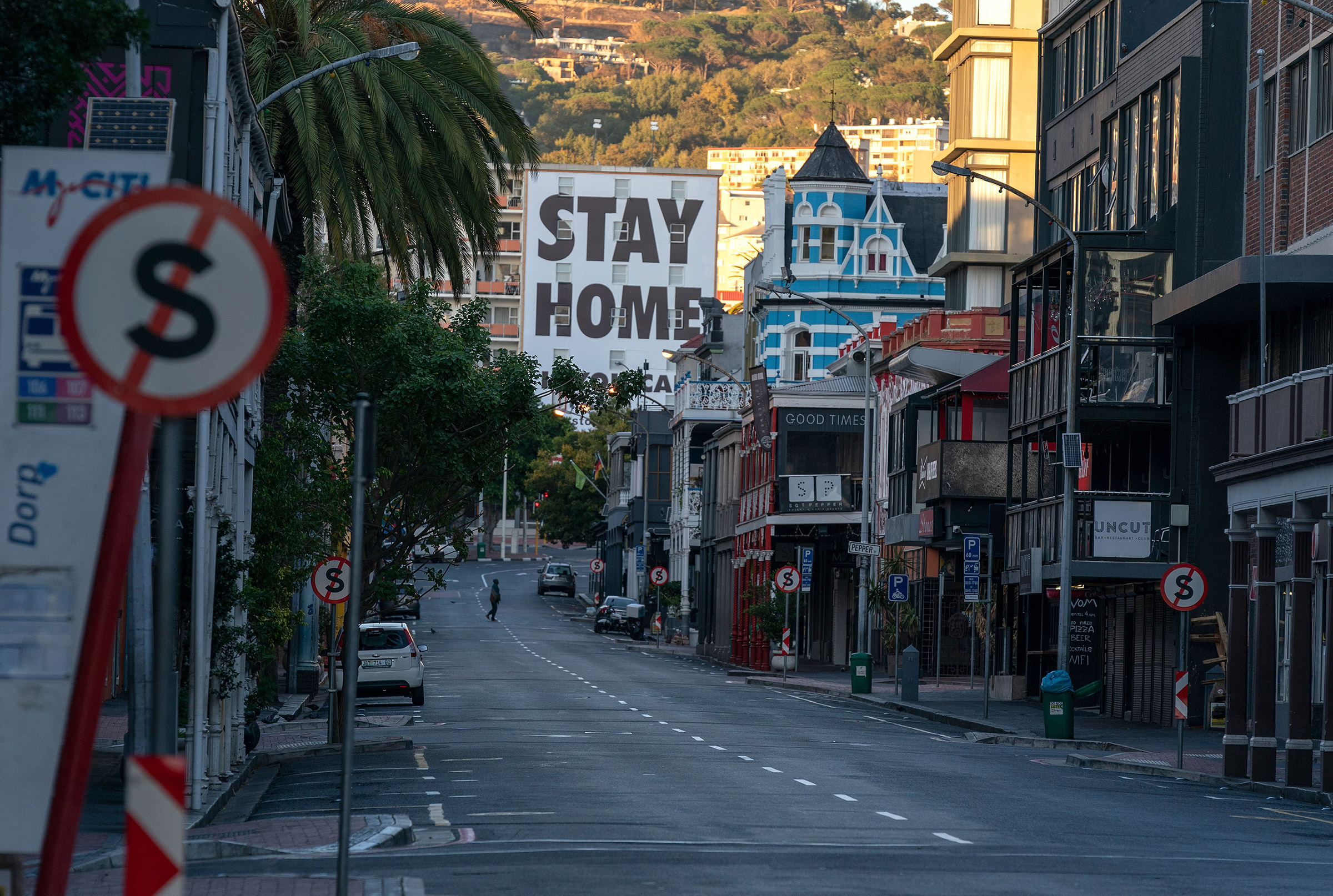 A man crosses a deserted street during day 1 of a 21 day national total lockdown in Cape Town