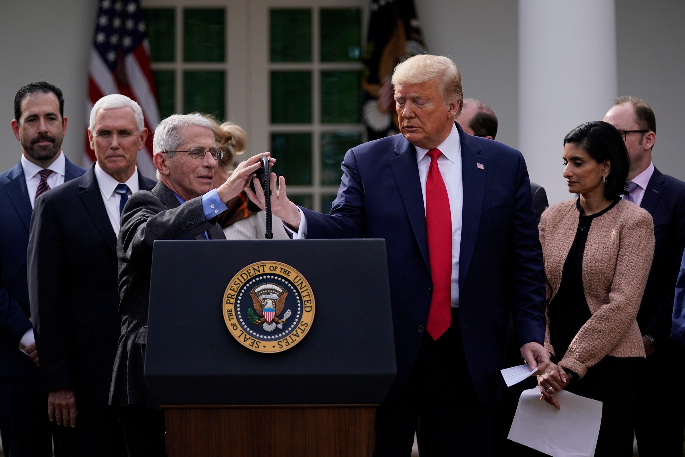 Trump and Fauci, at microphone, address reporters in the Rose Garden on March 13 (Evan Vucci—AP)