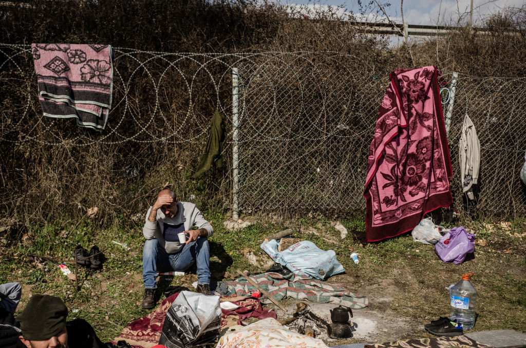 Migrants who came to Edirne, Turkey, to try and cross in Greece and after that to go to western Europe, gathered around a fire outside a bus station in Edirne on March 6, 2020. (Hristo Rusev—NurPhoto/Getty Images)