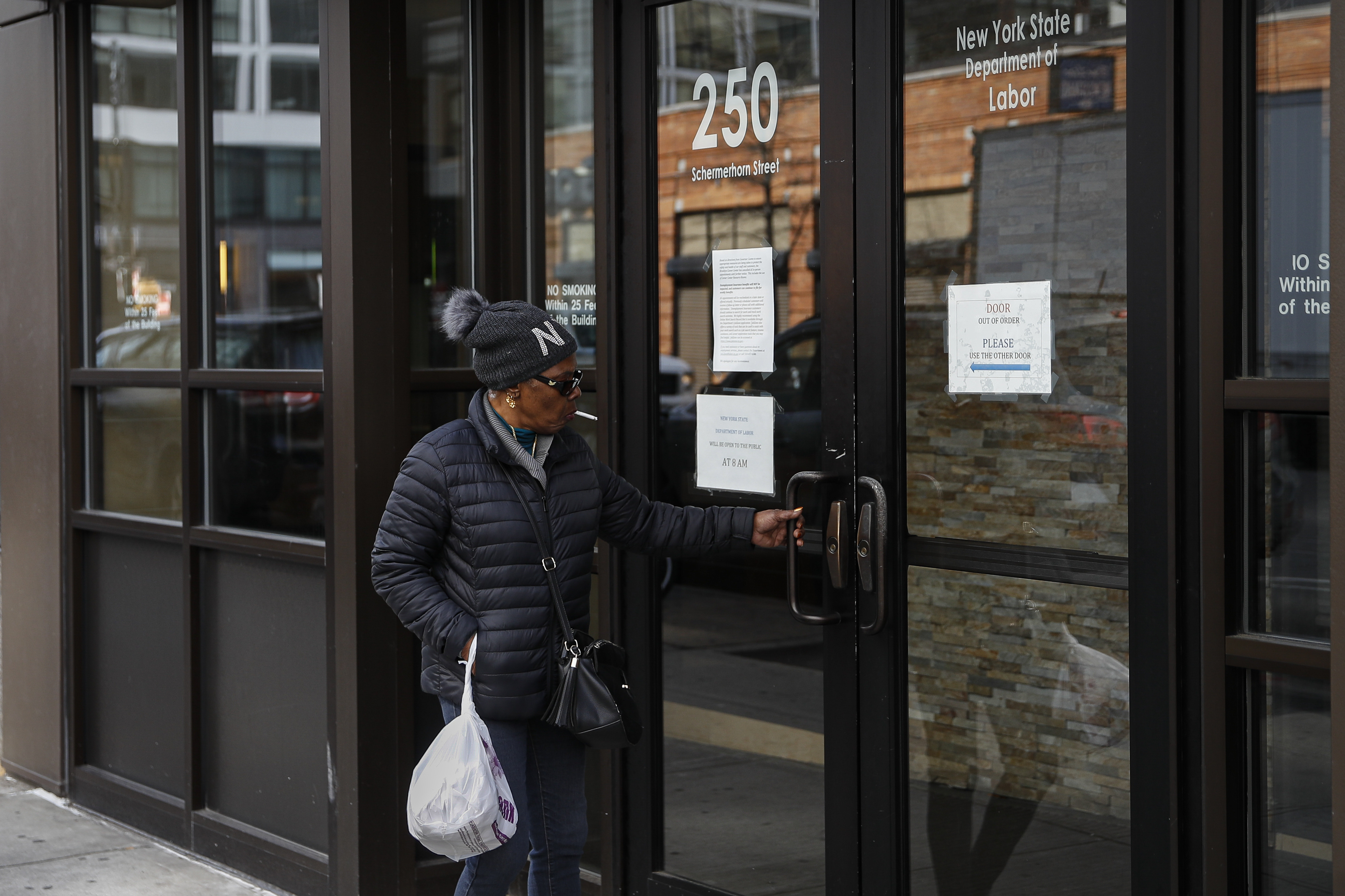 Visitors are unable to gain access to the Department of Labor due to closures over coronavirus concerns, Wednesday, March 18, 2020, in New York. (John Minchillo—AP)
