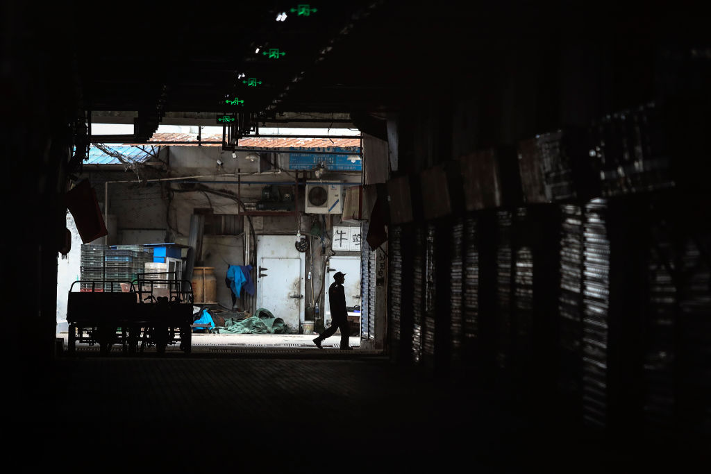 An employee walks past the closed Huanan Seafood Wholesale Market, which has been linked to cases of coronavirus, on Jan. 17, 2020 in Wuhan, Hubei province, China. Local authorities have confirmed that a second person in the city has died of a pneumonia-like virus since the outbreak started in December. (Getty Images)