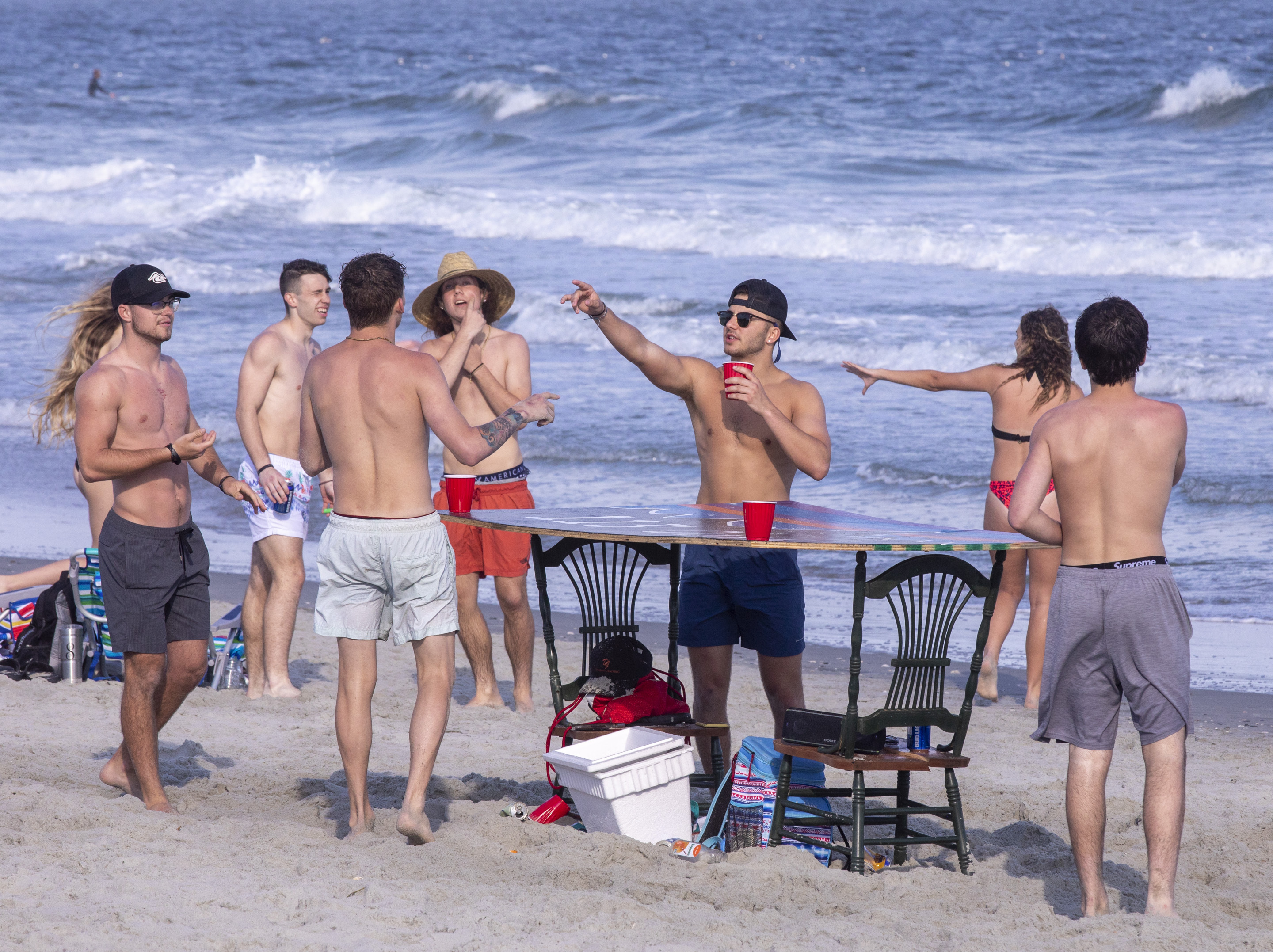 Despite warnings from government officials take caution and self distance because of coronavirus, many college students, some from Coastal Carolina University, hang out on the beach at 65th Avenue North in Myrtle Beach, S.C. on March 19, 2020.