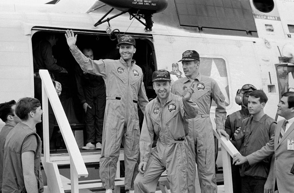 (Left to Right) Fred Haise, Jim Lovell and Jack Swigert, the crew of Apollo 13, step aboard the USS Iwo Jima, prime recovery ship for the mission, following splashdown and recovery operations in the South Pacific Ocean on April 17, 1970. (NASA)