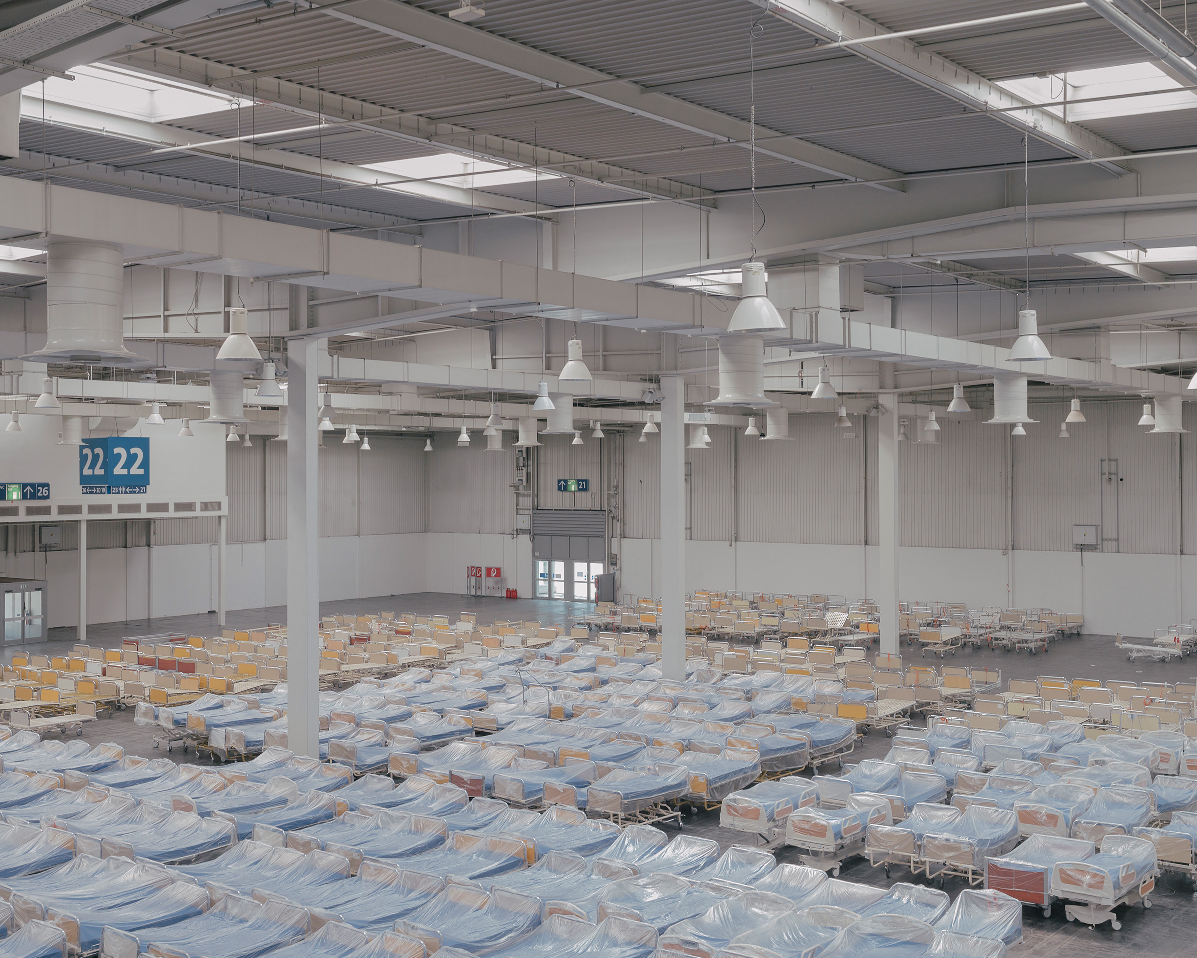 Hospital beds are set up on April 4 at a new hospital for treating coronavirus in an exhibition hall at the Hannover Messe trade fair in Hannover. Five hundred beds will be available across two halls. (Ingmar Björn Nolting—DOCKS Collective)