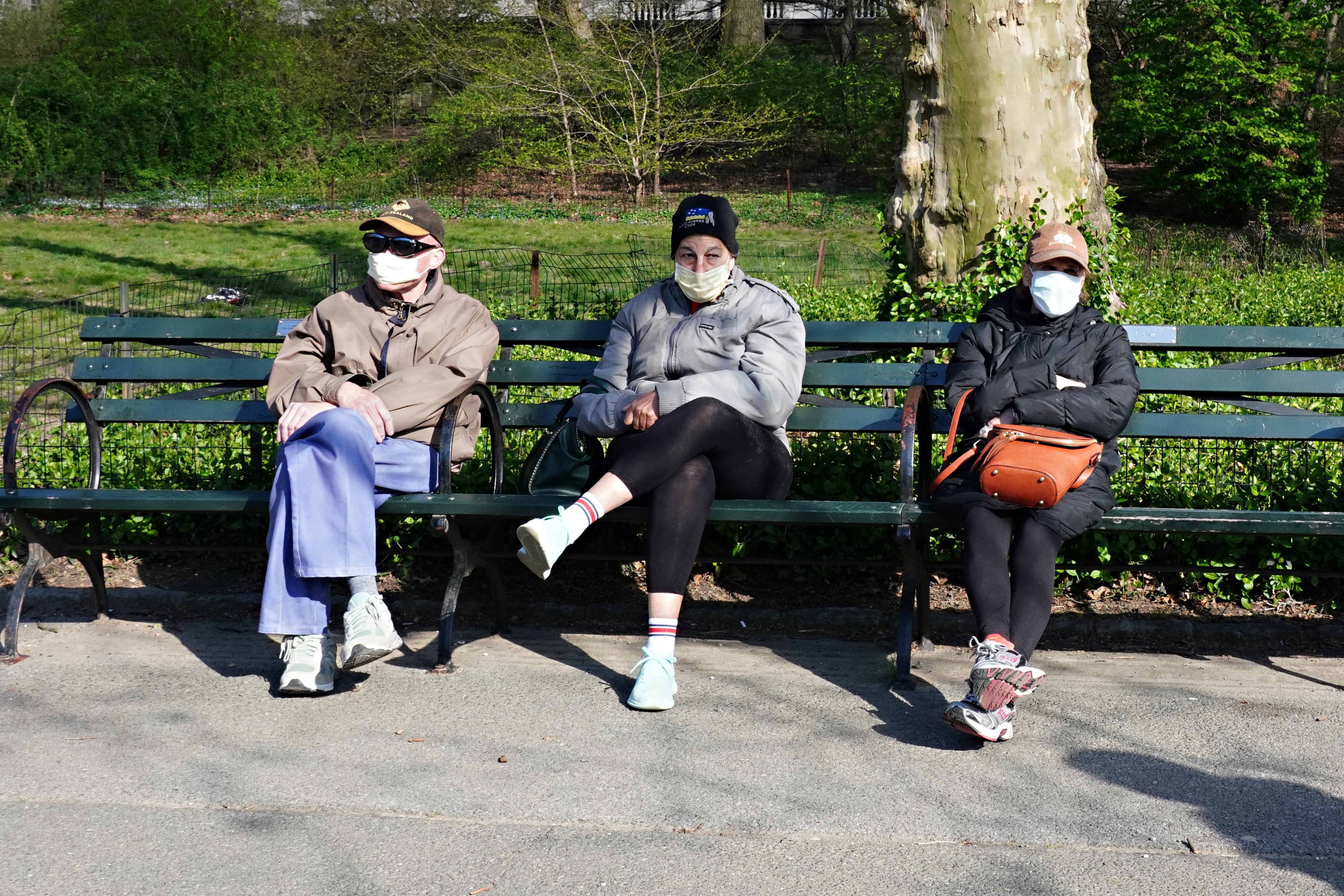 New Yorkers heed advice to wear masks to help control the spread of the coronavirus as they sit in Central Park in New York City on April 11, 2020. (Cindy Ord—Getty Images)