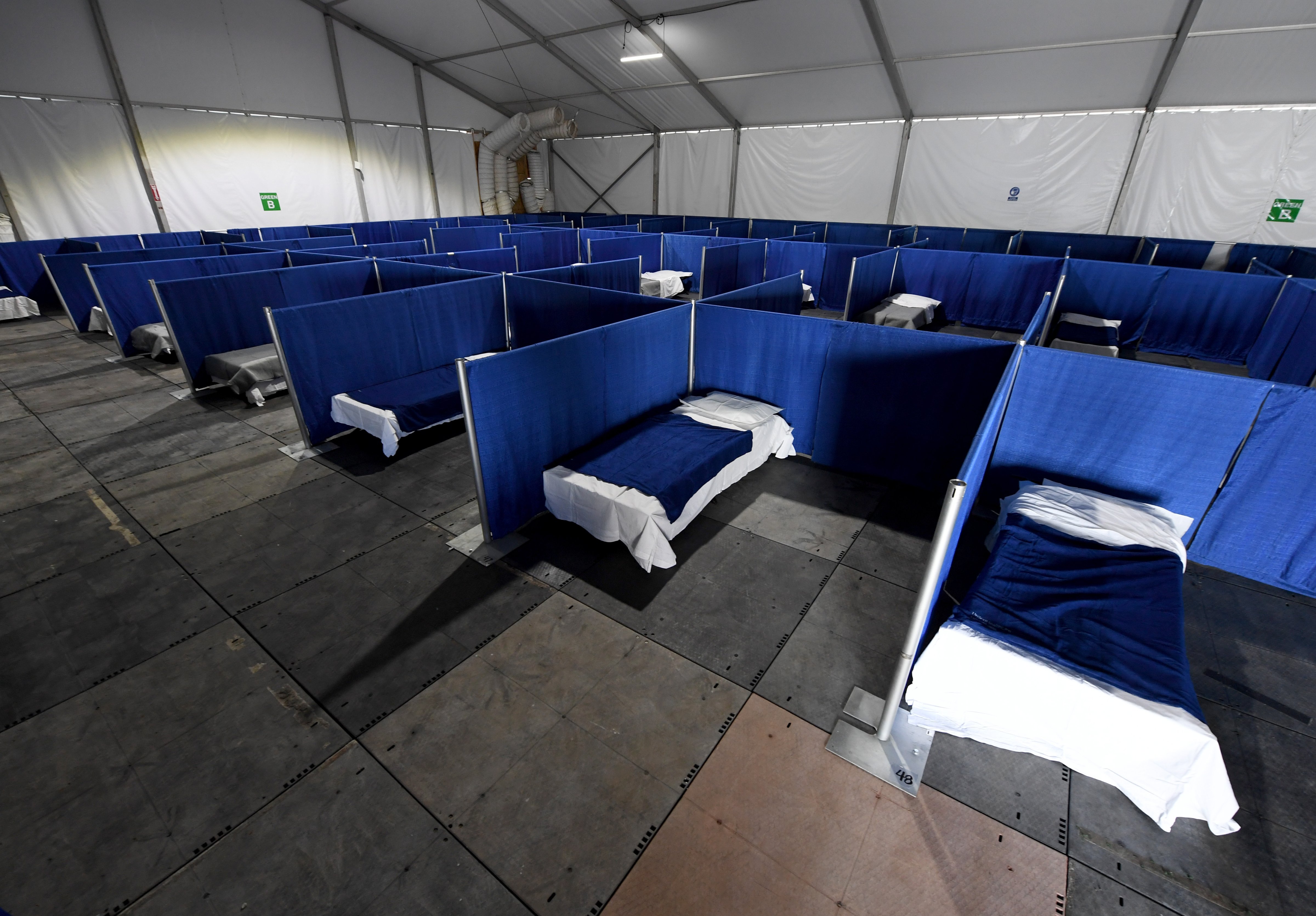 Cots are set up in a tent for homeless people who have nowhere to self-isolate in Las Vegas, Nevada, on April 13, 2020. The center will have separate areas for those requiring quarantine due to COVID-19, those with symptoms who have tested positive, and those who have tested positive but have no symptoms. (Ethan Miller—Getty Images)