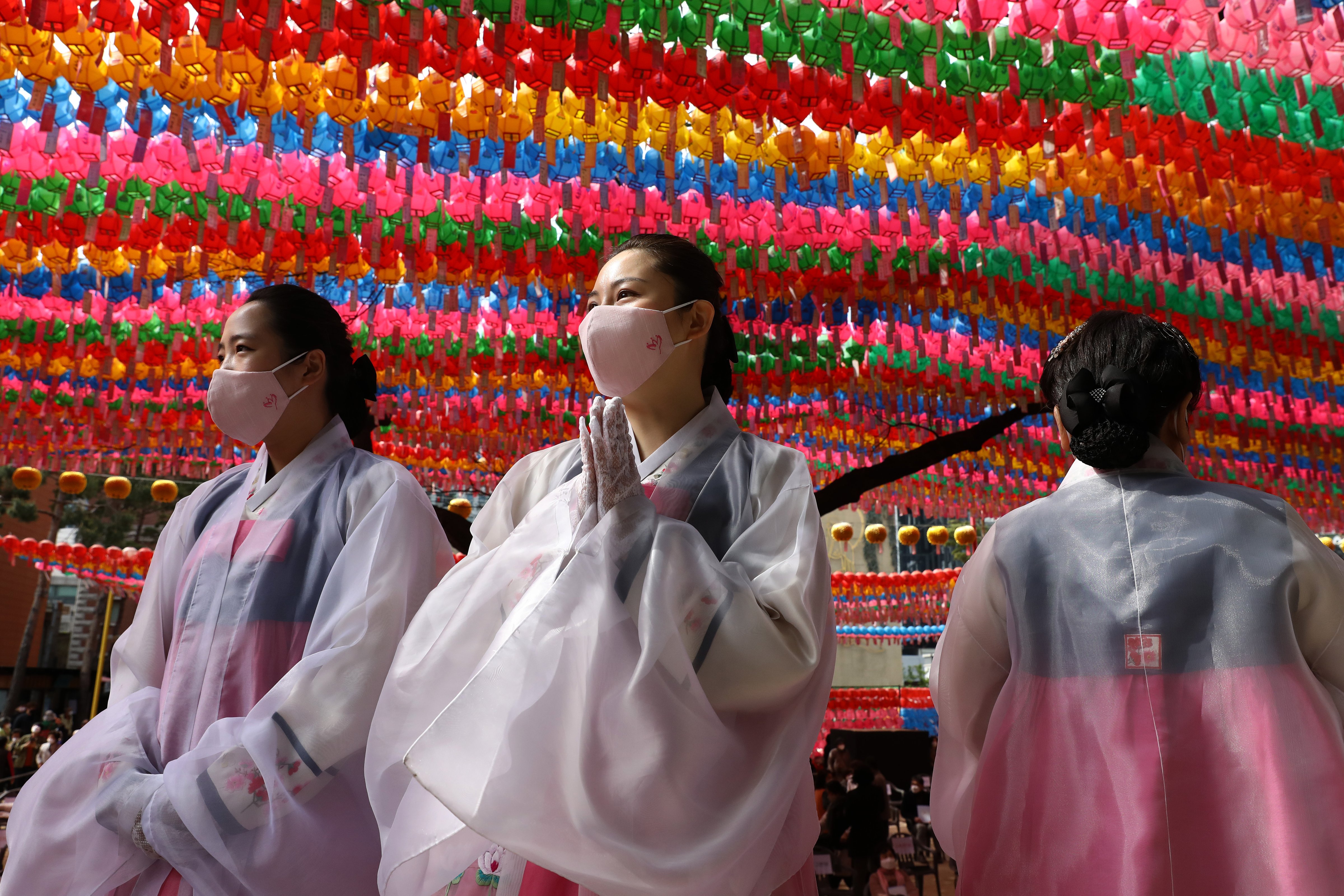 Buddhist believers wear masks as a preventive measure against the coronavirus (COVID-19), as they gather during a birthday of Buddha and service to pray for overcoming the coronavirus (COVID-19) pandemic at Jogyesa Temple on April 30, 2020 in Seoul, South Korea. (Chung Sung-Jun/Getty Images)