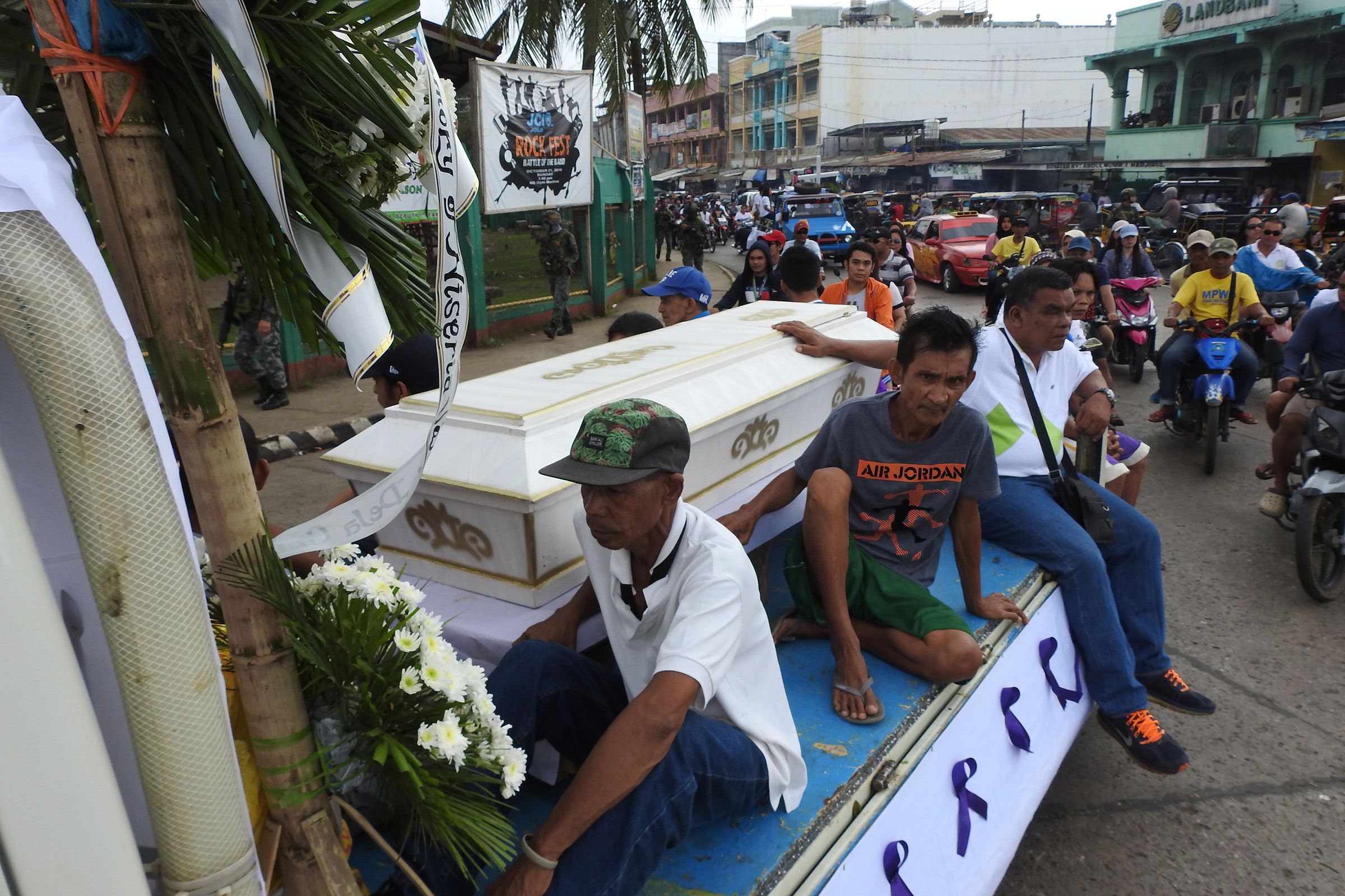Mourners ride on a hearse during the funeral procession of a victim killed in the Jan. 27, 2019 cathedral bombing in Jolo, Sulu province on the southern island of Mindanao, Philippines. (Nickee Butlangan—AFP via Getty Images)