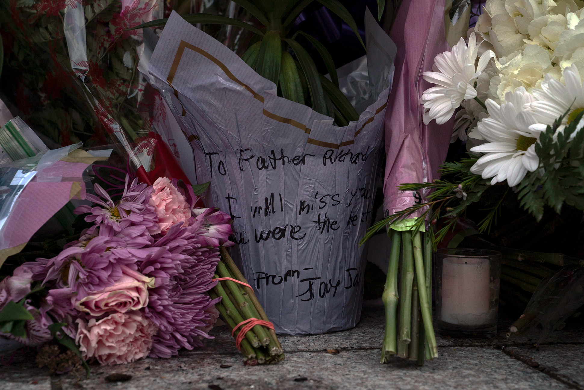 Flowers at a memorial for Monsignor Richard Guastella, who died from Covid-19 outside the doors of St. Clare Catholic Church in Staten Island, N.Y., April 10, 2020. (Paul Moakley for TIME)