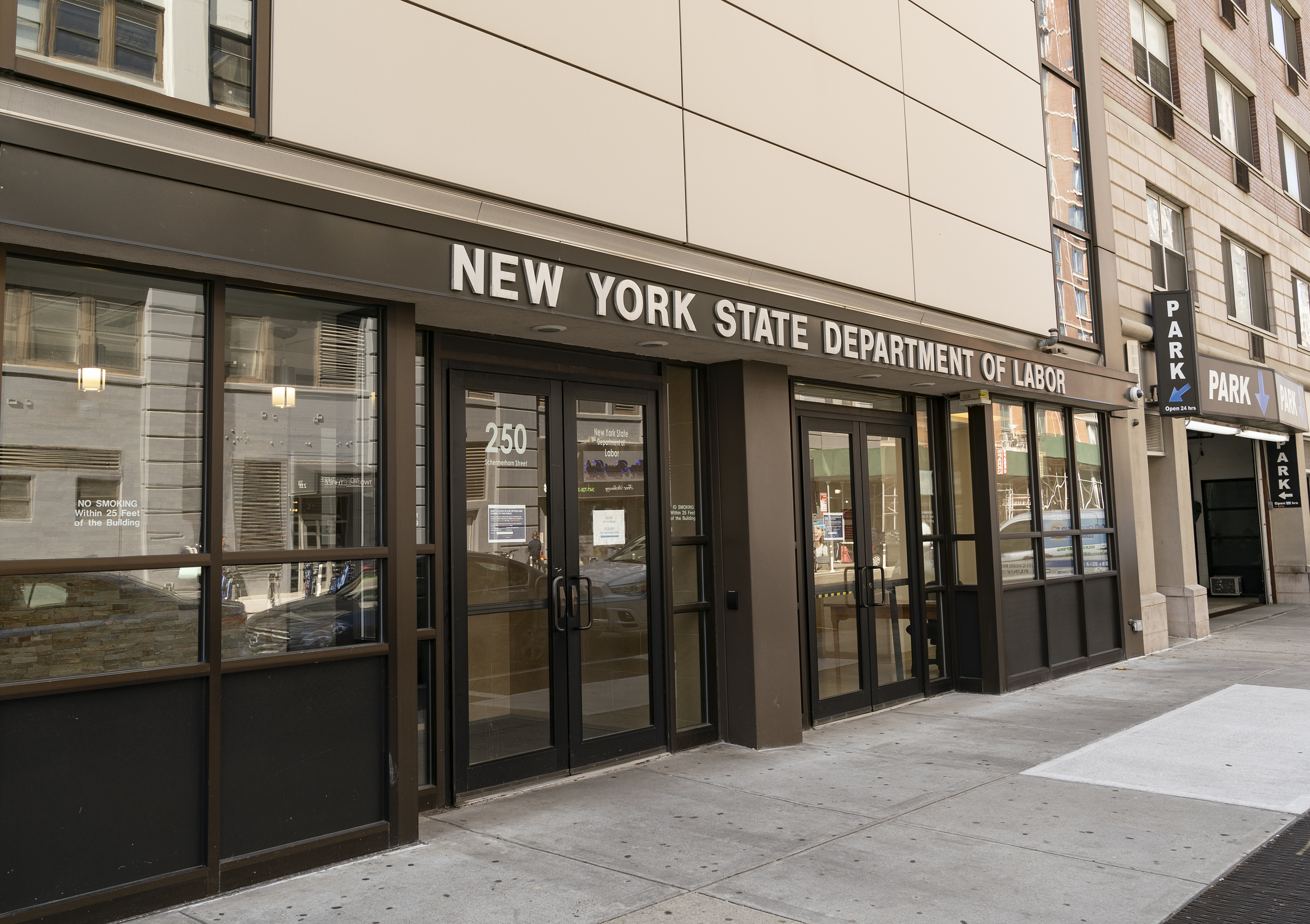 The Brooklyn office of the New York State Department of Labor on March 26, 2020. A sign on the door said the office was closed due to COVID-19 and told people seeking unemployment benefits to apply online or call. (Lev Radin—Pacific Press/LightRocket/Getty Images)