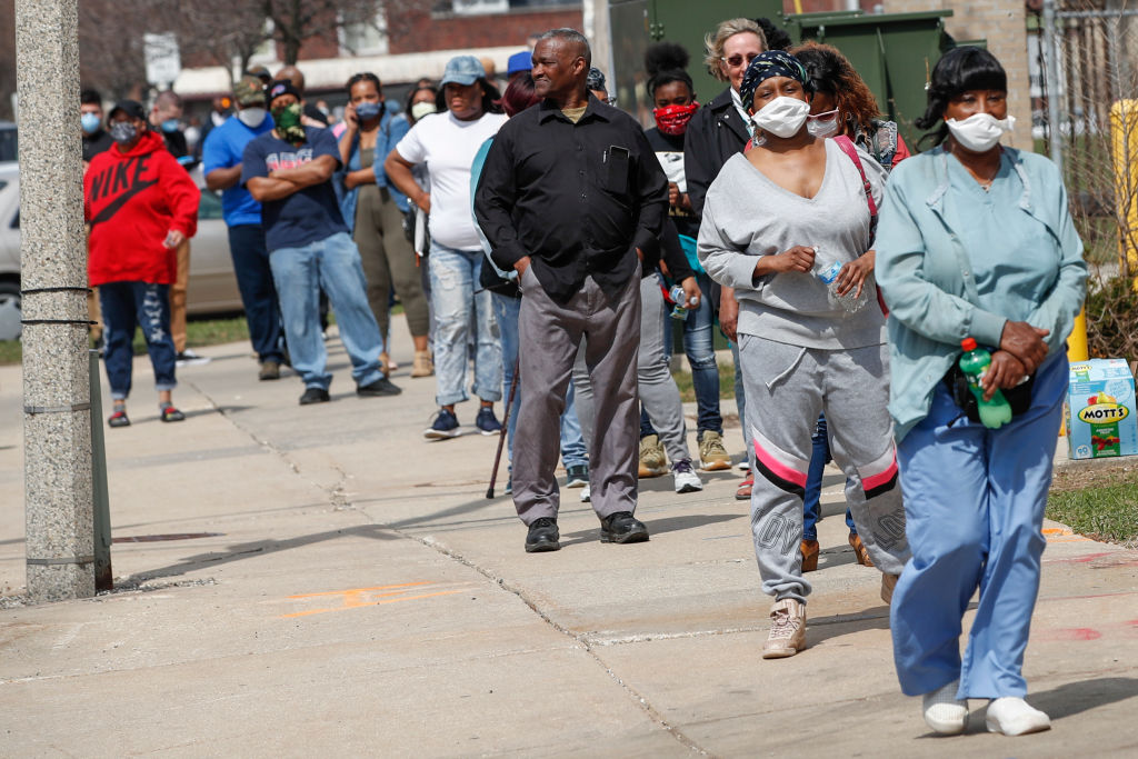 Residents wait in long line to vote in a presidential primary election outside the Riverside High School in Milwaukee, Wisconsin, on April 7, 2020. (Kamil Krzaczynski—AFP/Getty Images)