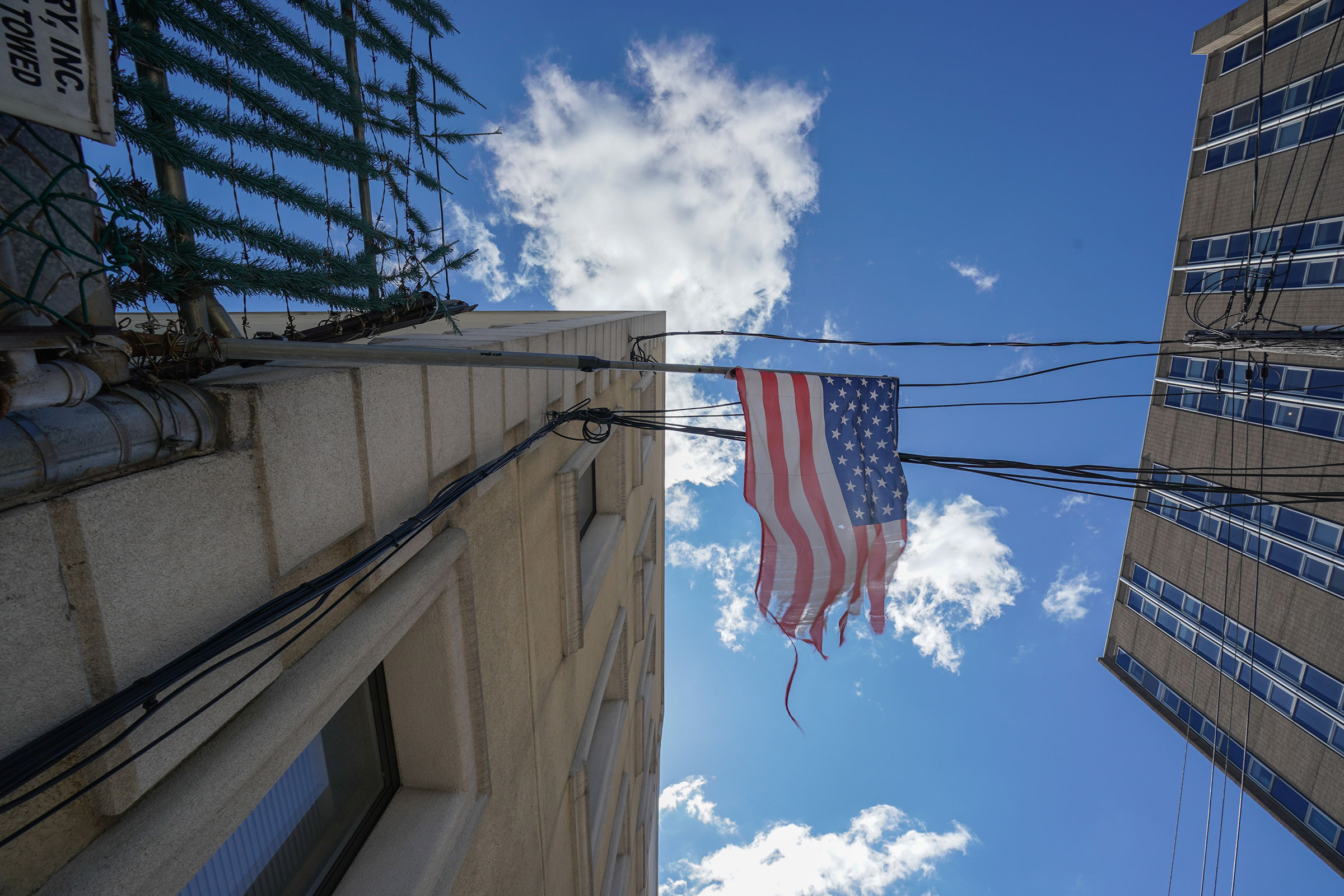 A tattered American flag hangs from a fence across the street from Wyckoff Hospital in Brooklyn, N.Y. on April 4, 2020. (Bryan R. Smith—AFP/Getty Images)