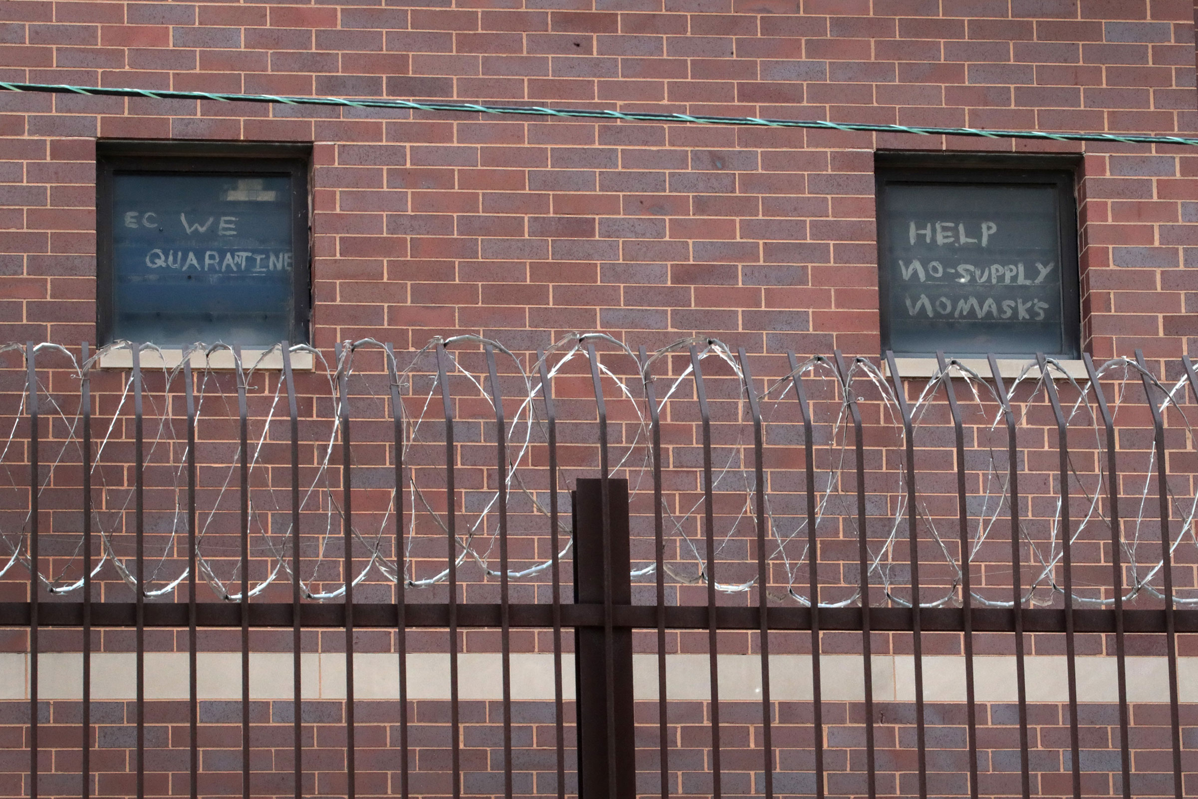 Signs pleading for help hang in windows at the Cook County jail complex on April 09, 2020 in Chicago. (Scott Olson—Getty Images)