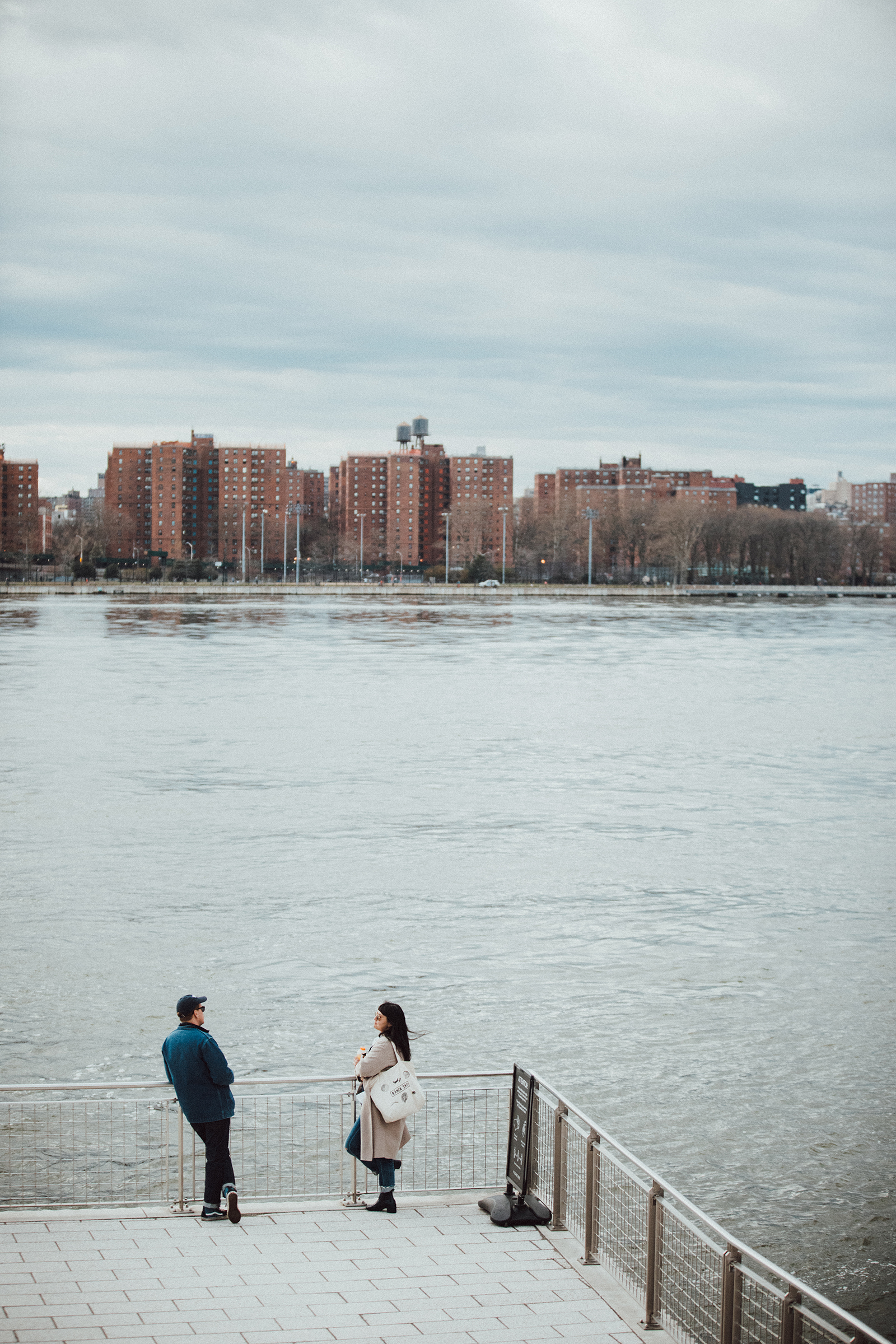 A couple in Domino Park in Williamsburg, Brooklyn on April 4th, 2020. (Katia Repina)