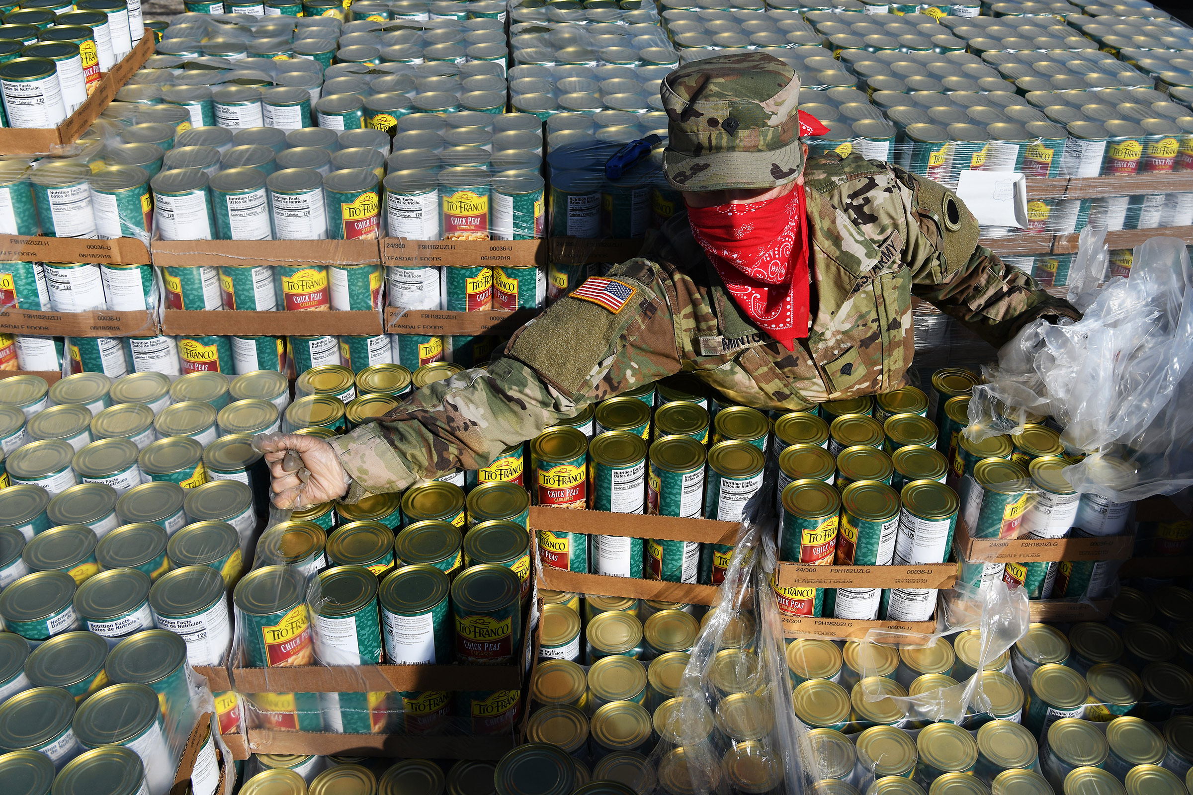 U.S. Army Spc. Rose Minton unpacks pallets of food at Wright State University's Nutter Center in Fairborn, Ohio, on April 21, 2020.