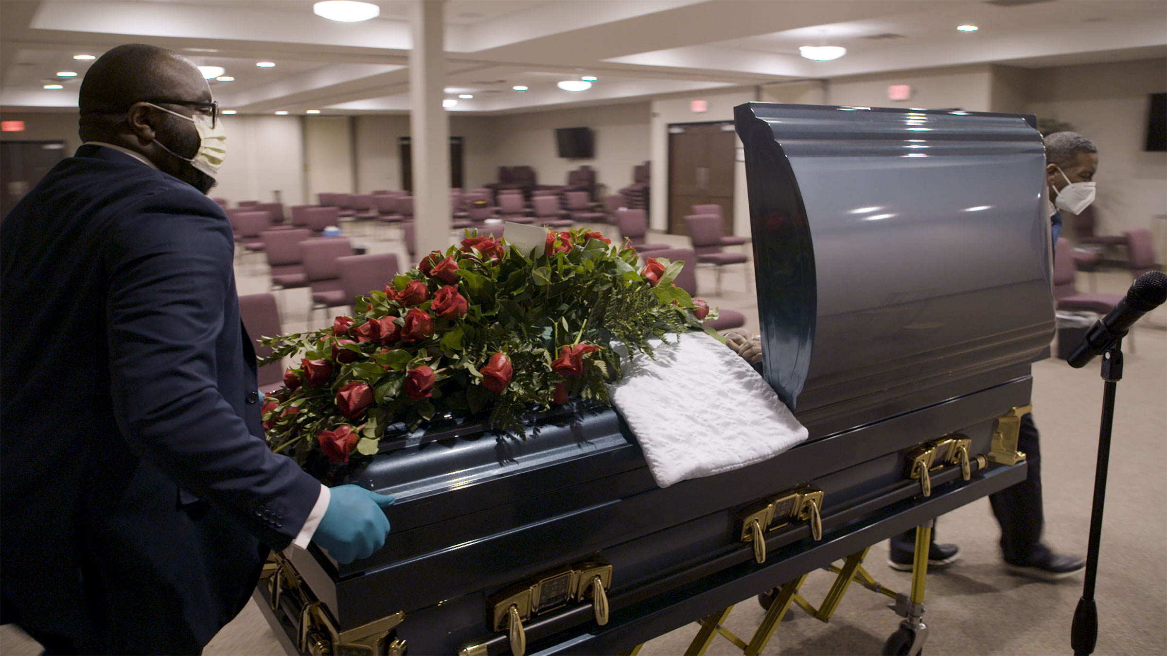 A man pushes a casket inside a Detroit funeral home